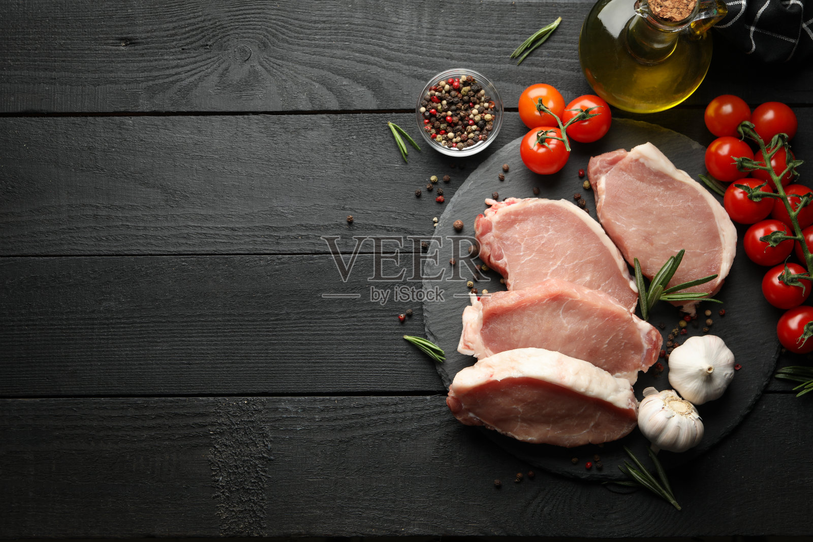 用牛排的生肉和木制背景上的配料组成照片摄影图片