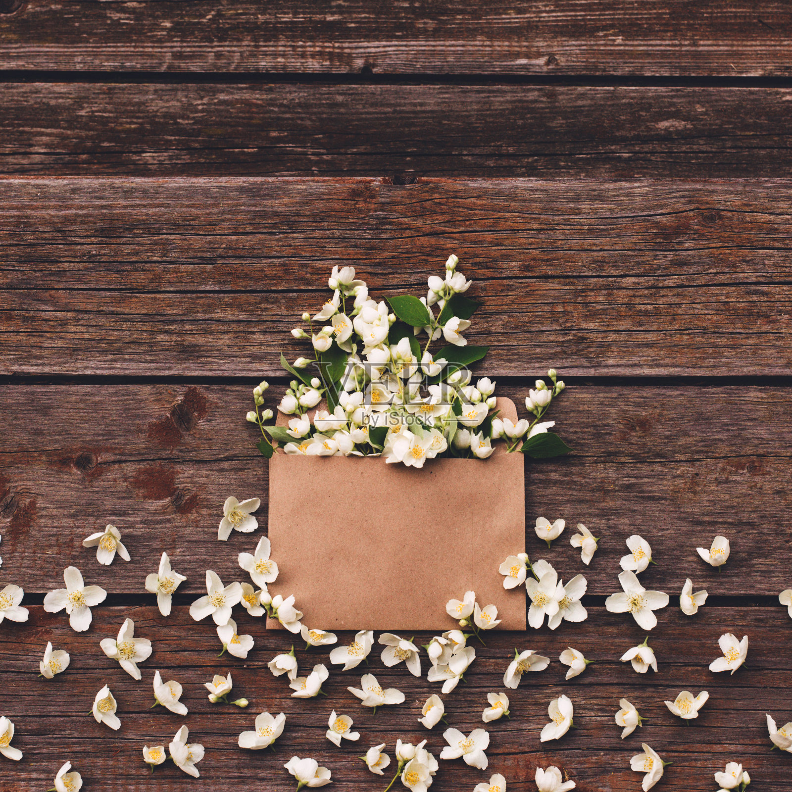 木质背景上的茉莉花信封。照片摄影图片