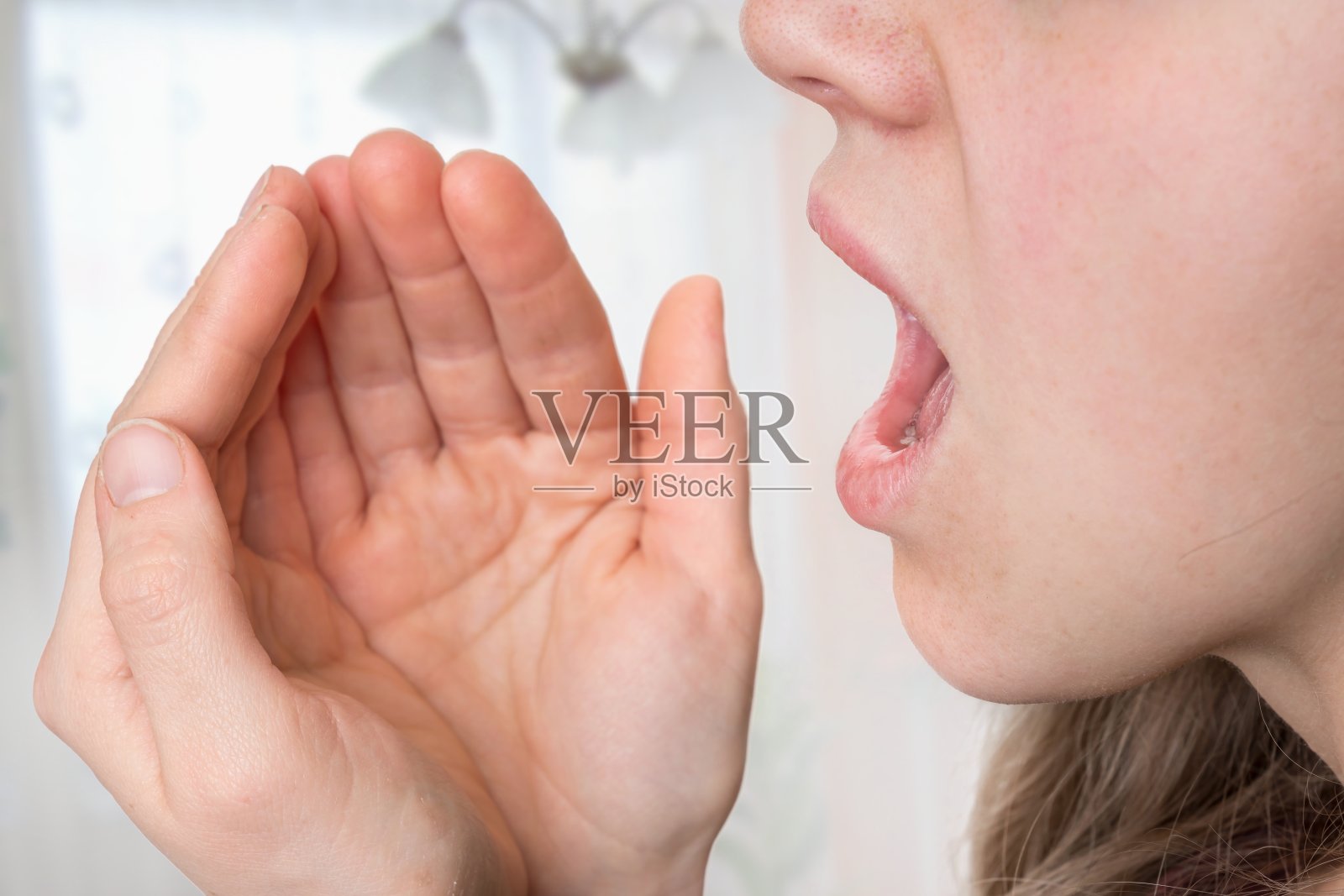 一个女人正在用手掌检查她的呼吸照片摄影图片