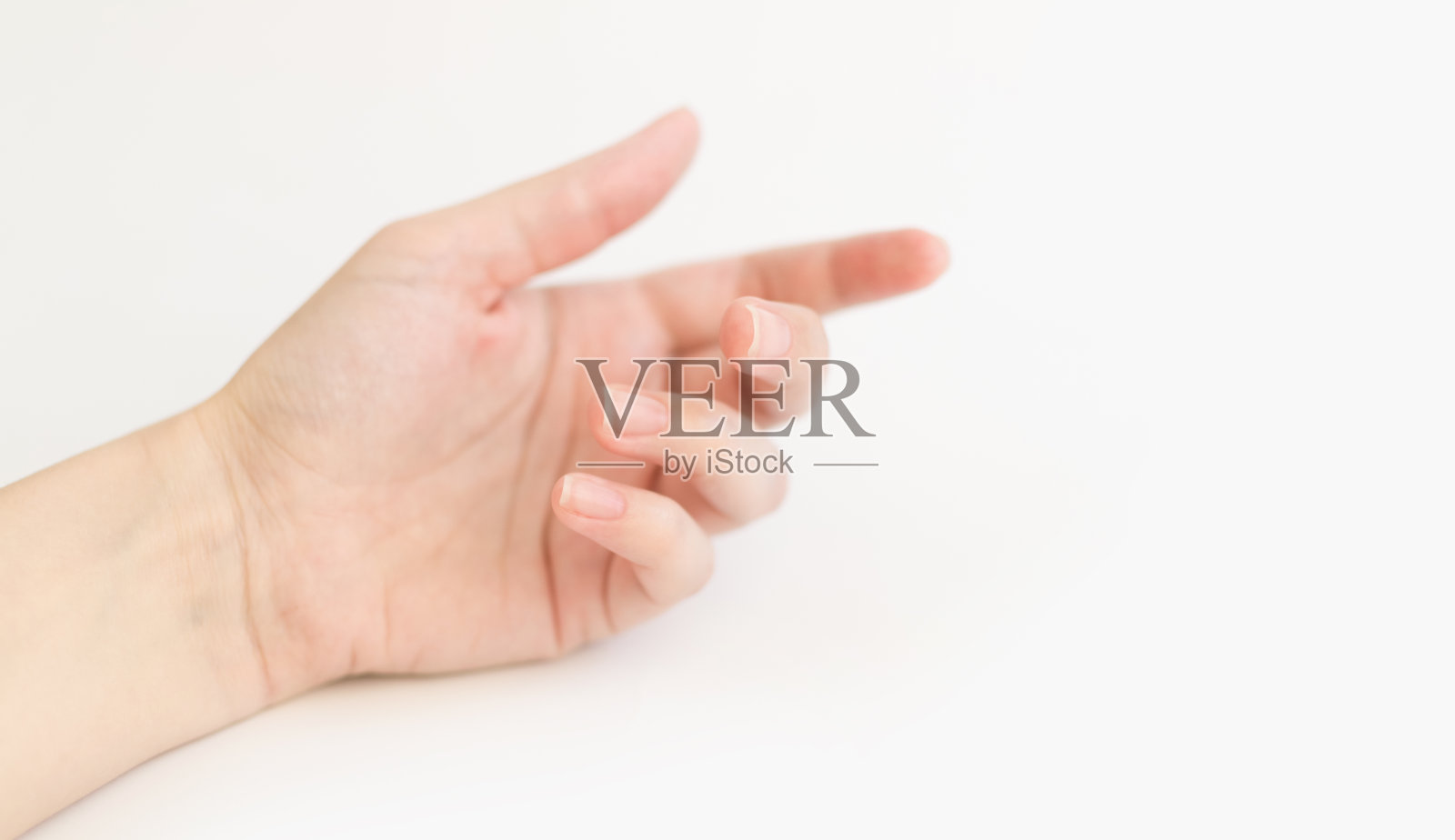 近看女人用指甲软方形的手拿东西。女性保持虚拟对象。在家做指甲护理。副本的空间。照片摄影图片