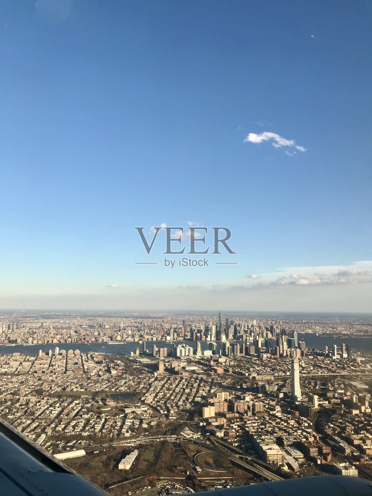 从飞机机翼窗口拍摄的国际旅行航拍照片:曼哈顿的天际线，美国著名的大都市，其高耸的摩天大楼为背景照片摄影图片