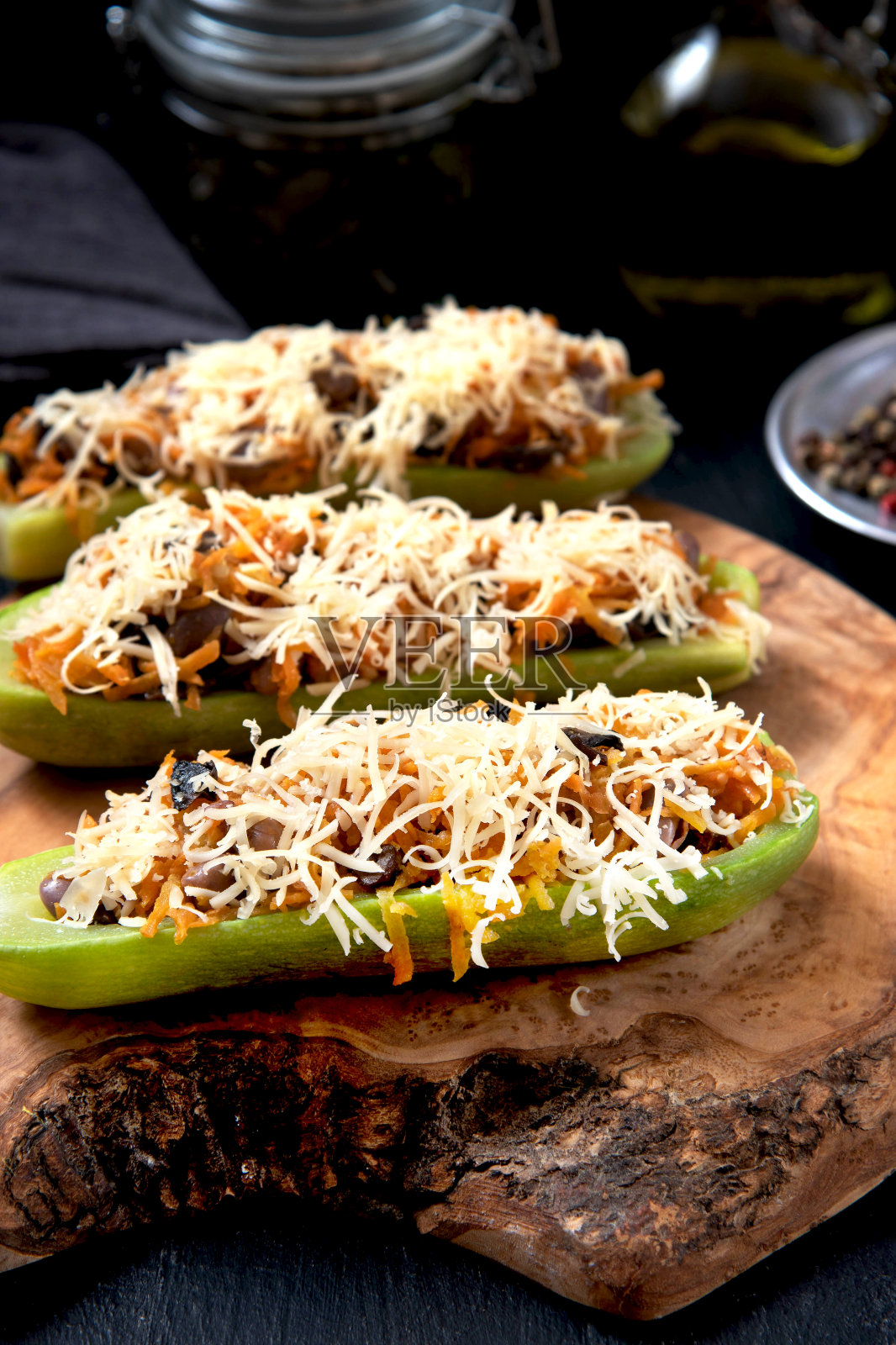 夹着蔬菜和奶酪的西葫芦放在木板上照片摄影图片