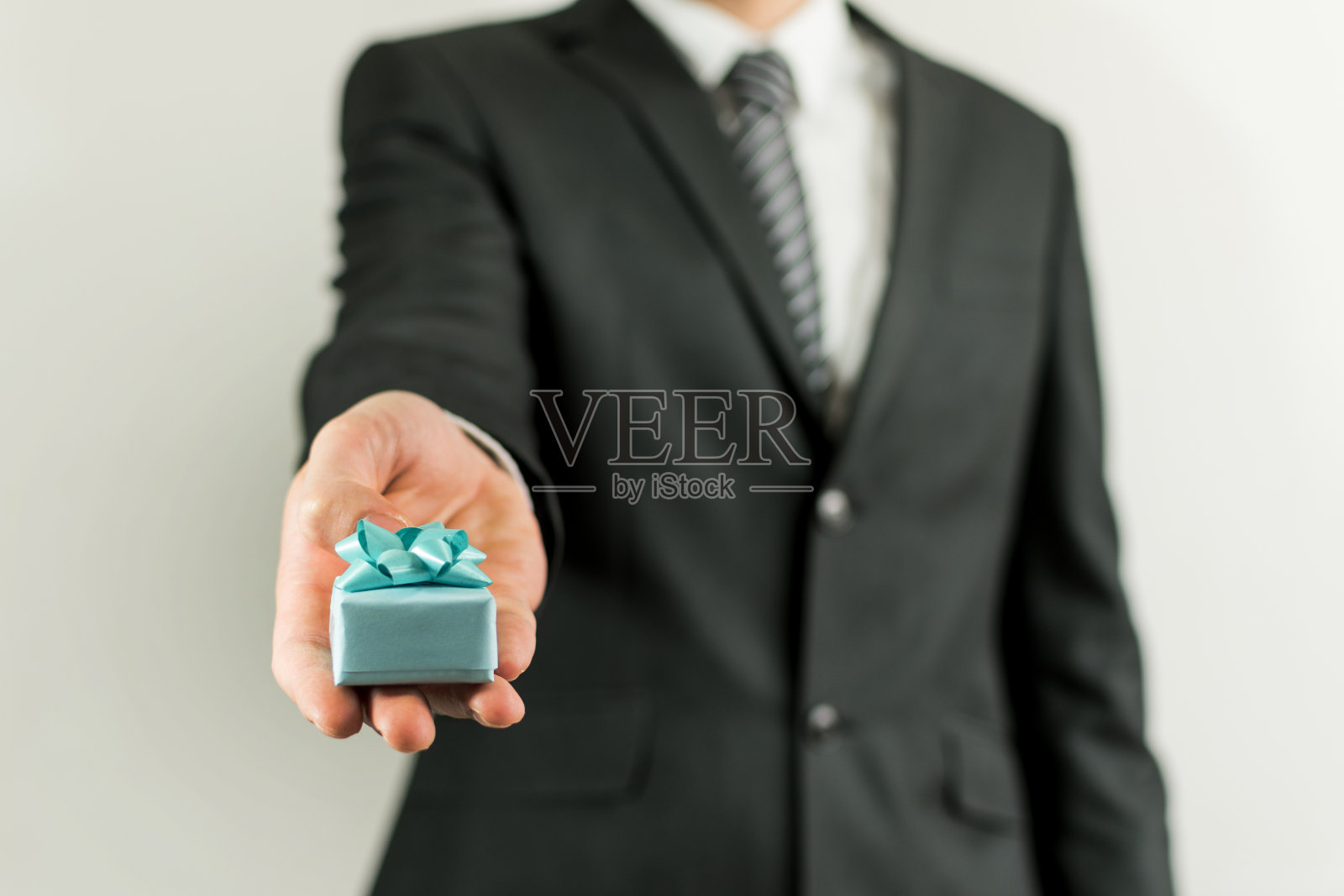 身穿黑色西装，系着领带的年轻男人照片摄影图片