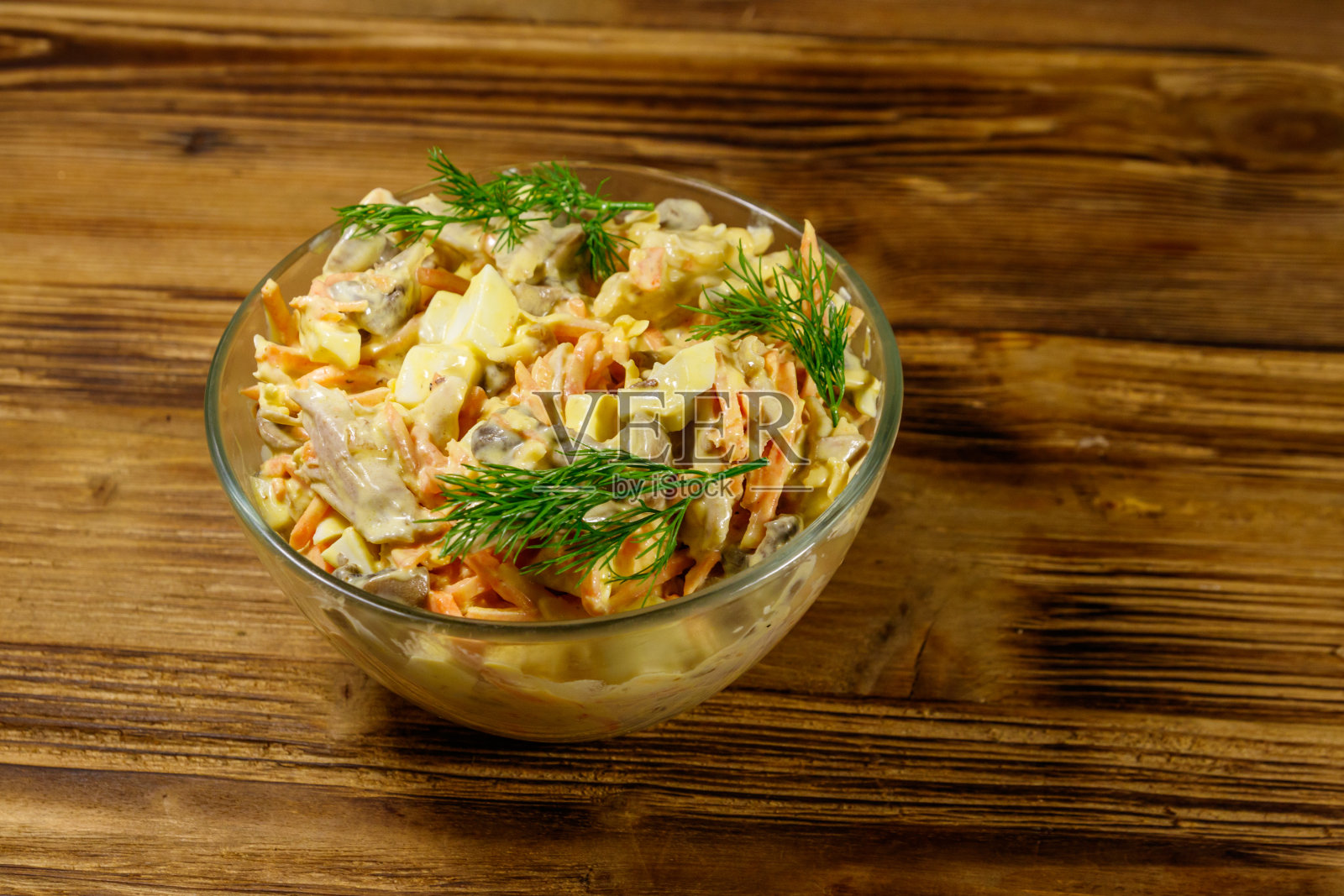 美味的沙拉配鸡胸肉，烤蘑菇，胡萝卜，磨碎的奶酪，鸡蛋和蛋黄酱放在木桌上照片摄影图片