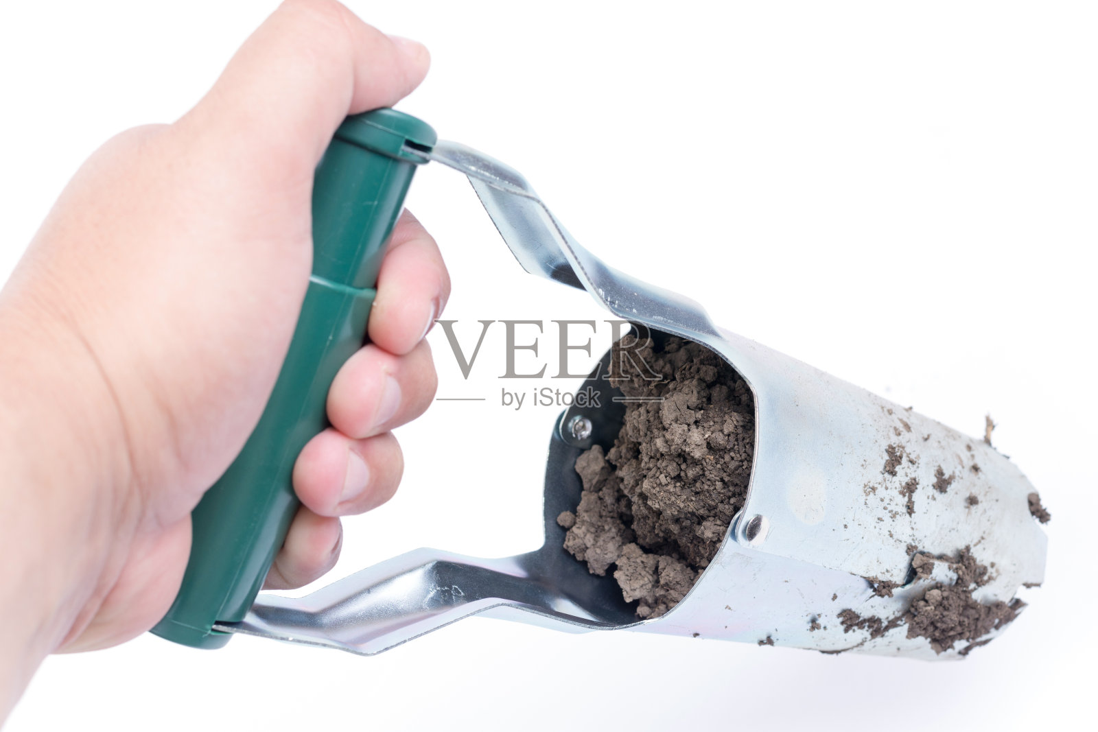 手持金属工具，用于挖洞和种植水果和蔬菜照片摄影图片