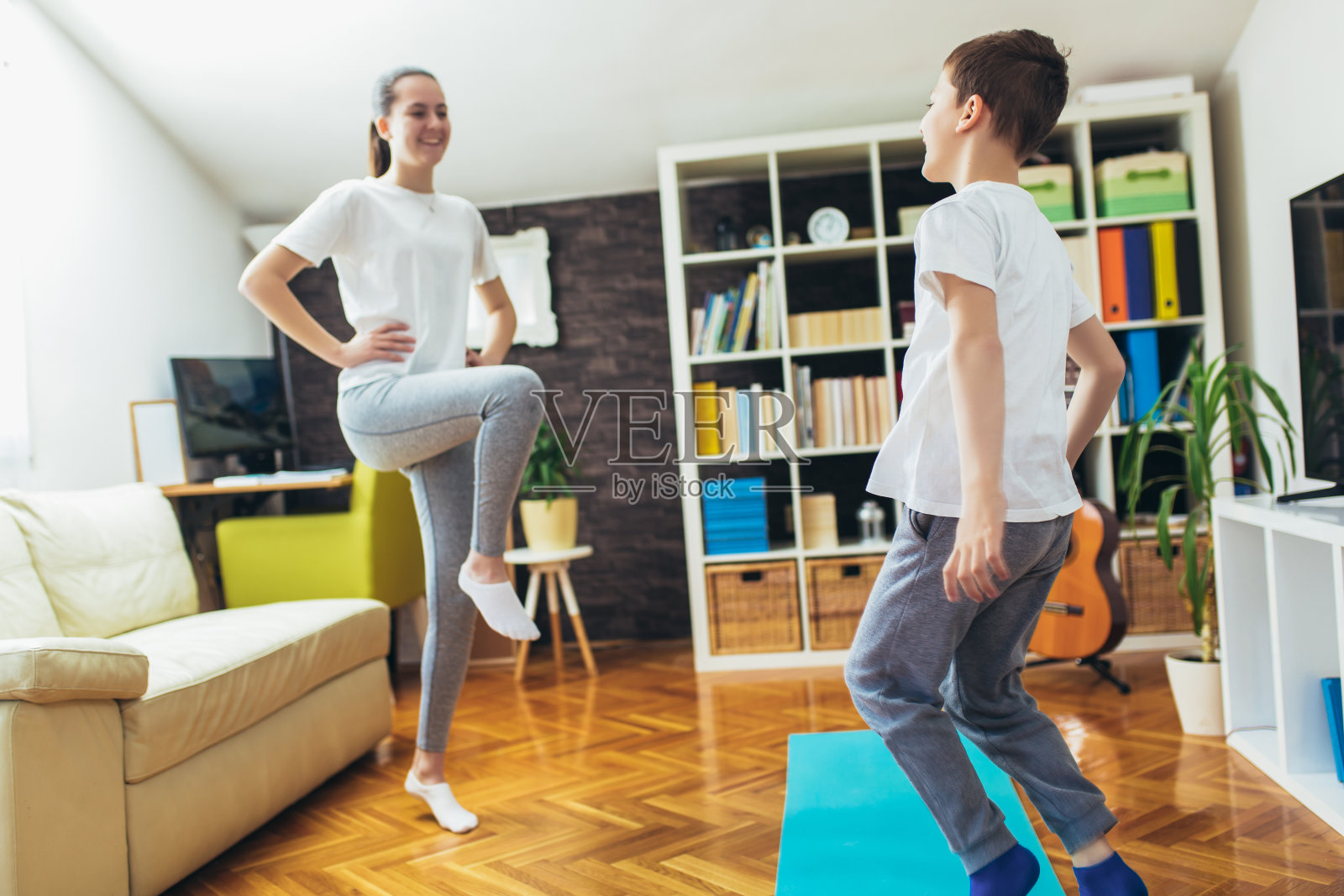 孩子们在家锻炼。家庭在家里锻炼。照片摄影图片