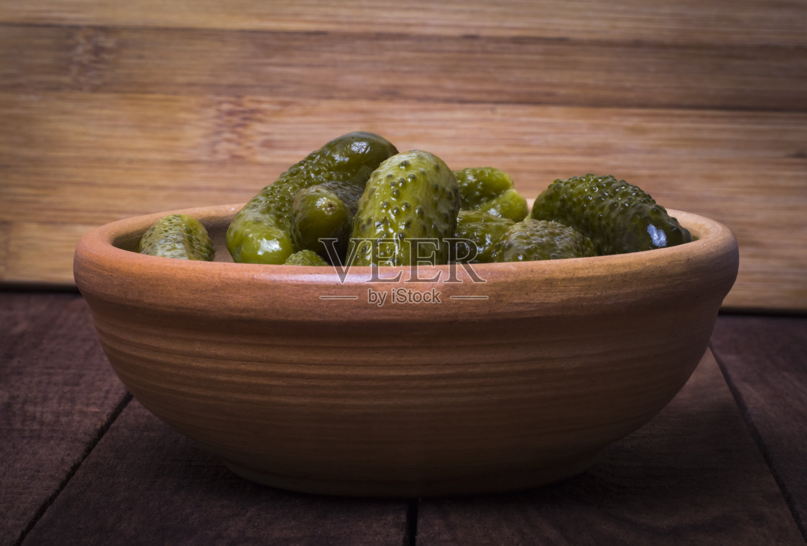 陶土碗里的腌菜，在黑暗的乡村背景下，侧视图照片摄影图片