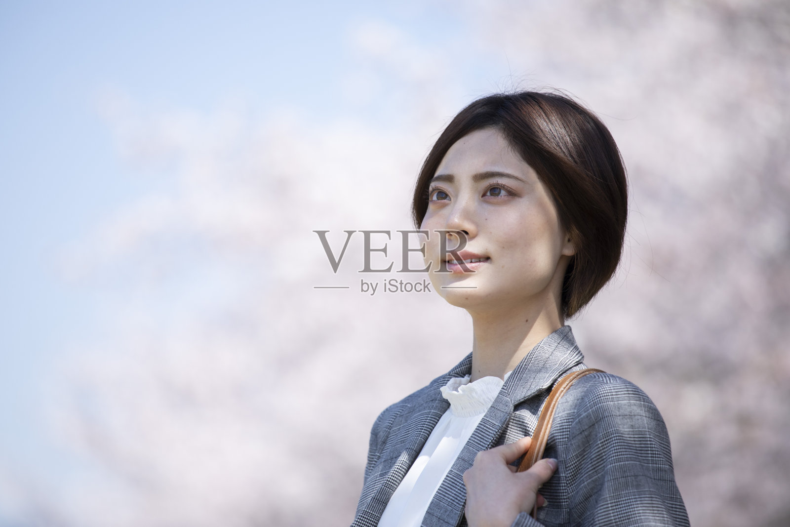 年轻的女商人，穿着樱花图案的套装照片摄影图片