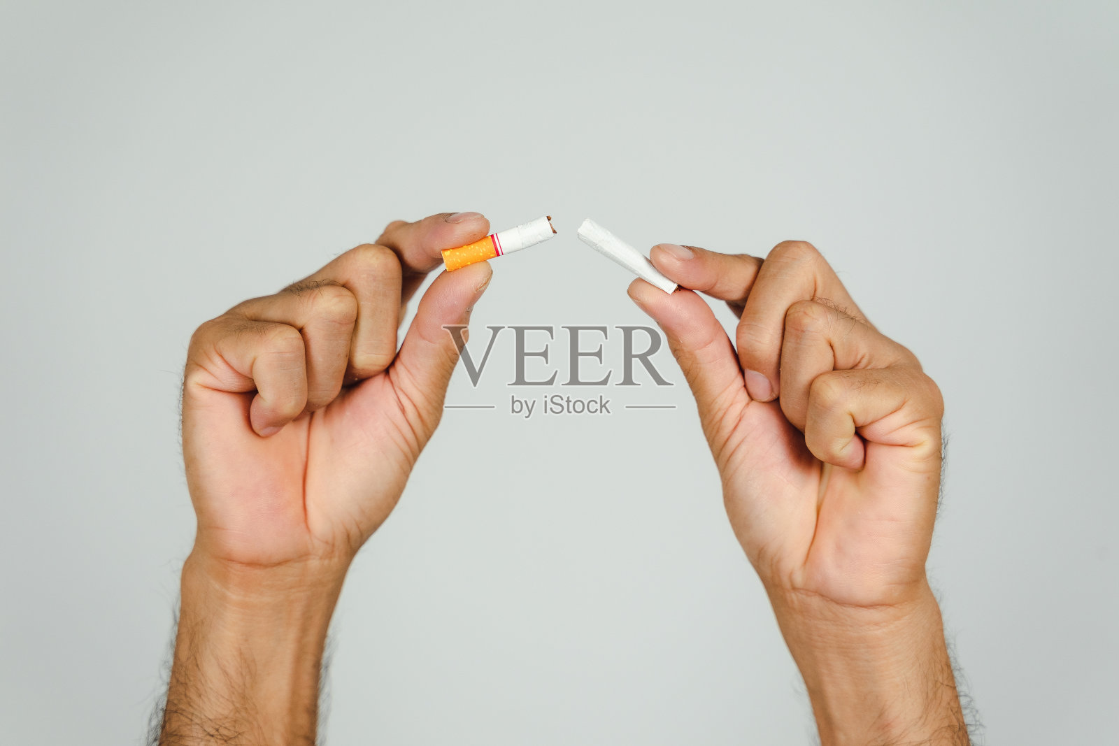 男子手捏香烟，概念戒烟，世界无烟日。照片摄影图片