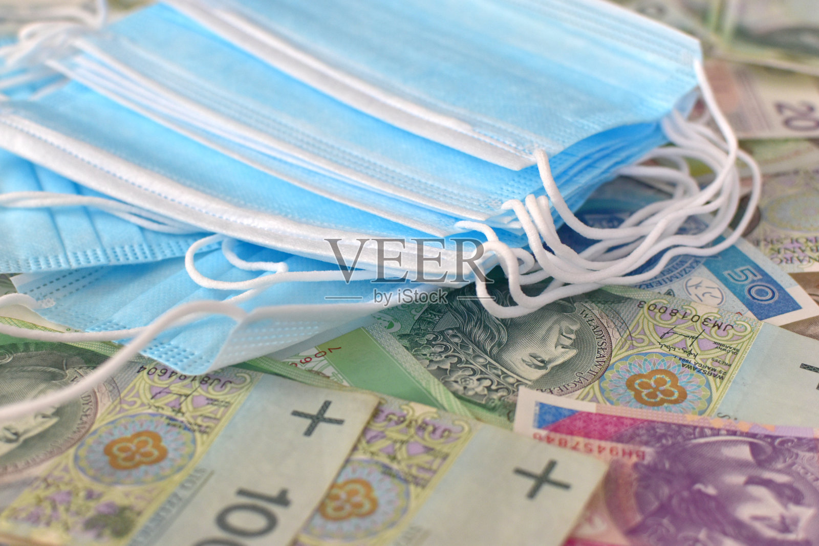 波兰各种面额的钞票和卫生口罩照片摄影图片