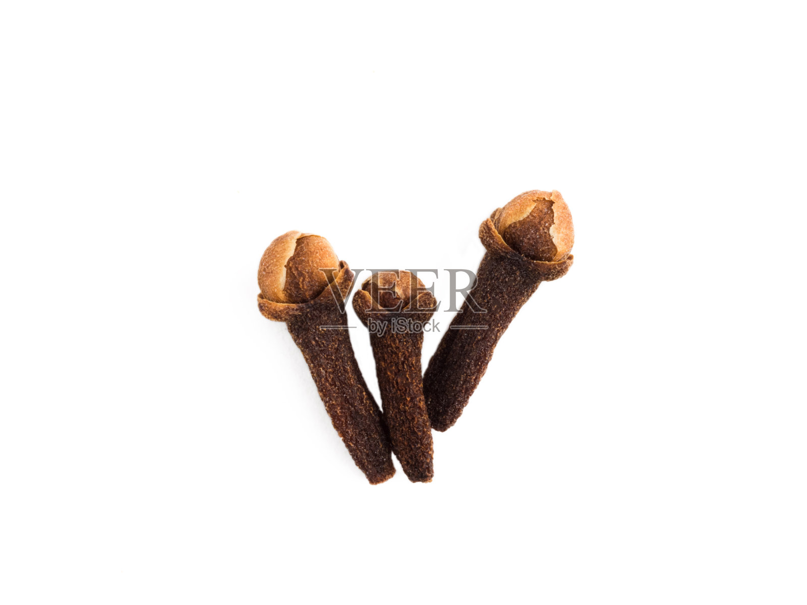 在白色孤立的背景上放三根香料丁香。健康饮食的概念照片摄影图片