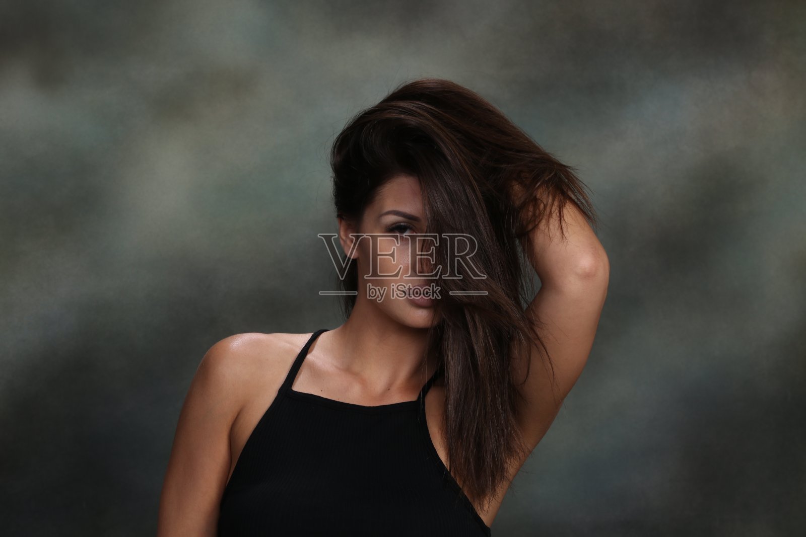 迷人的，性感的肌肉深色的白人女孩在工作室在孤立的背景摆姿势。照片摄影图片