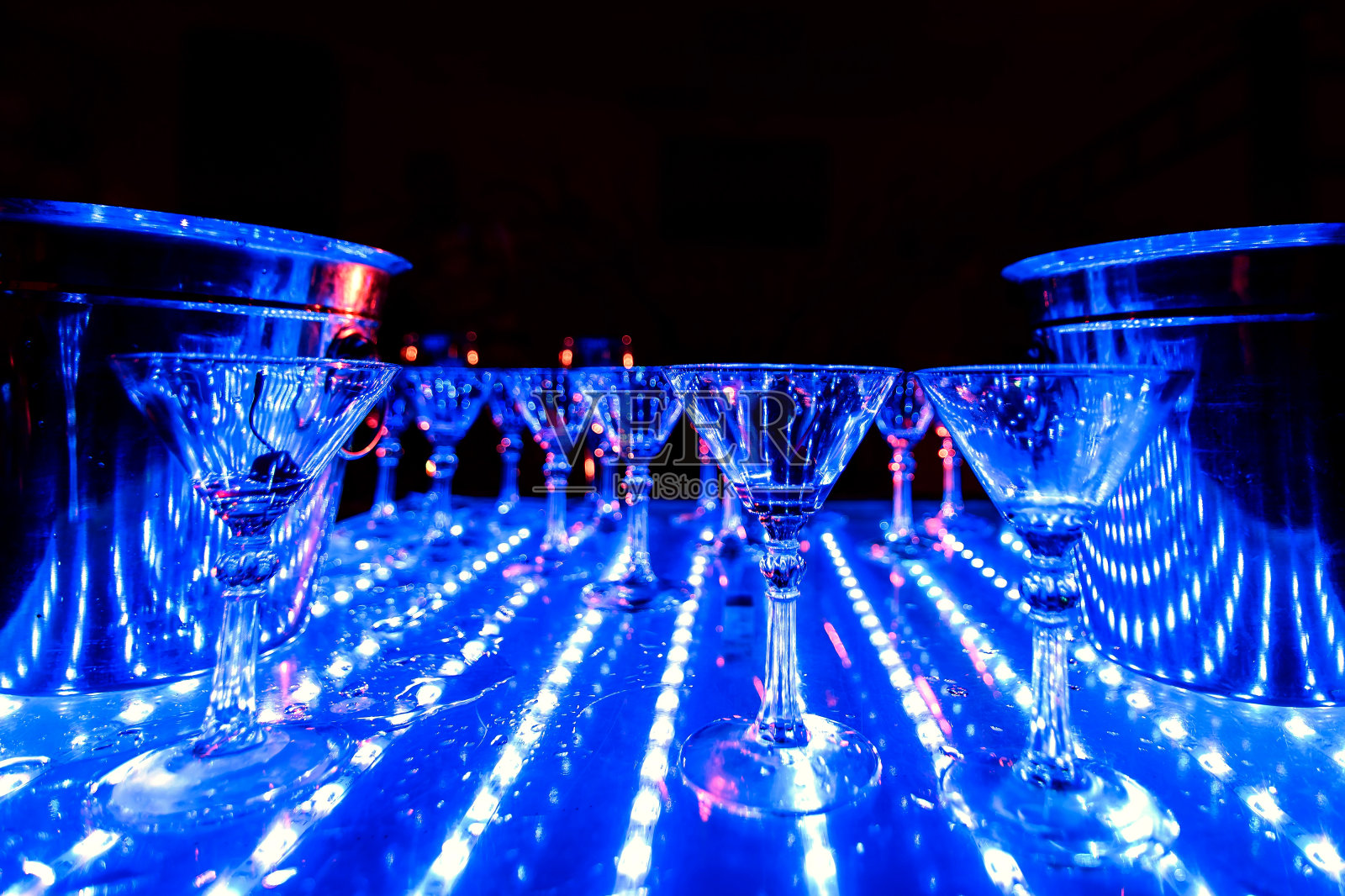 桌上有紫外线灯和空的鸡尾酒杯照片摄影图片