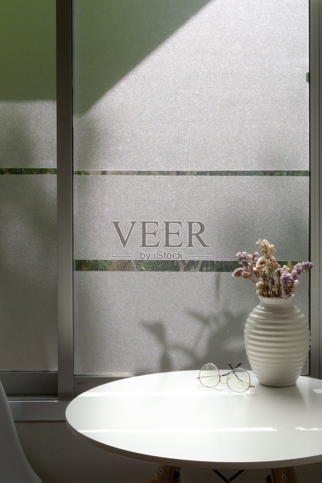 近距离观看咖啡桌旁边的窗户花瓶，眼镜和复印空间照片摄影图片