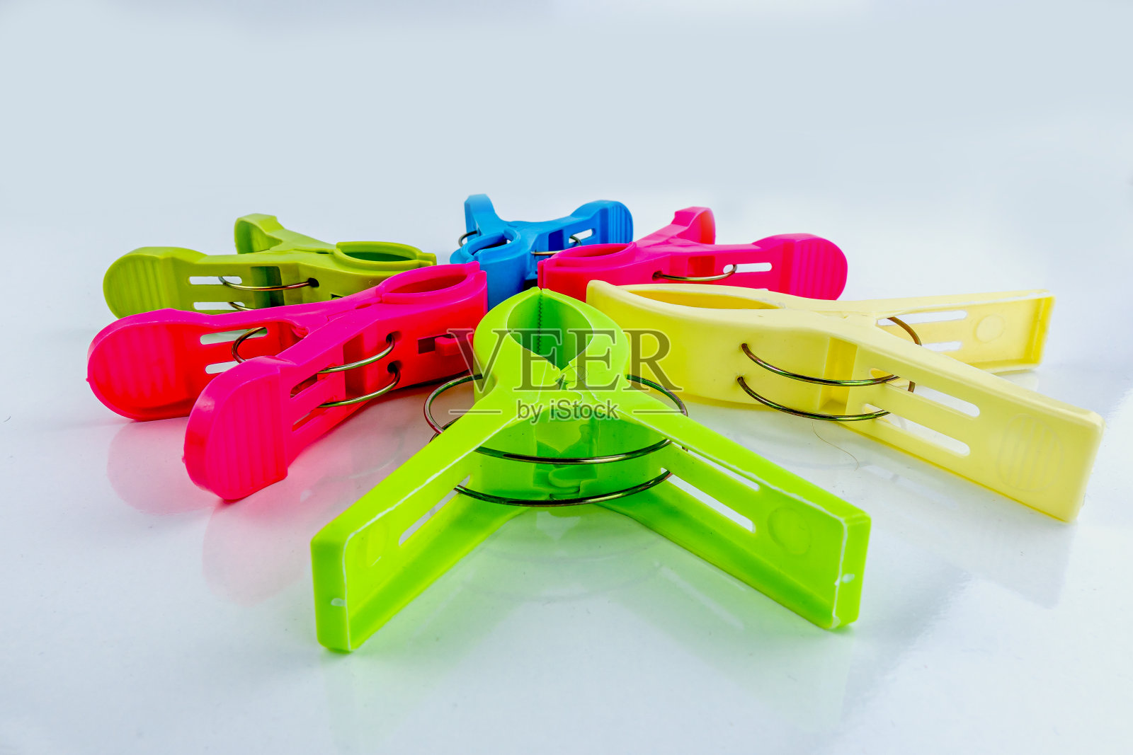 白色背景上的彩色塑料衣夹照片摄影图片