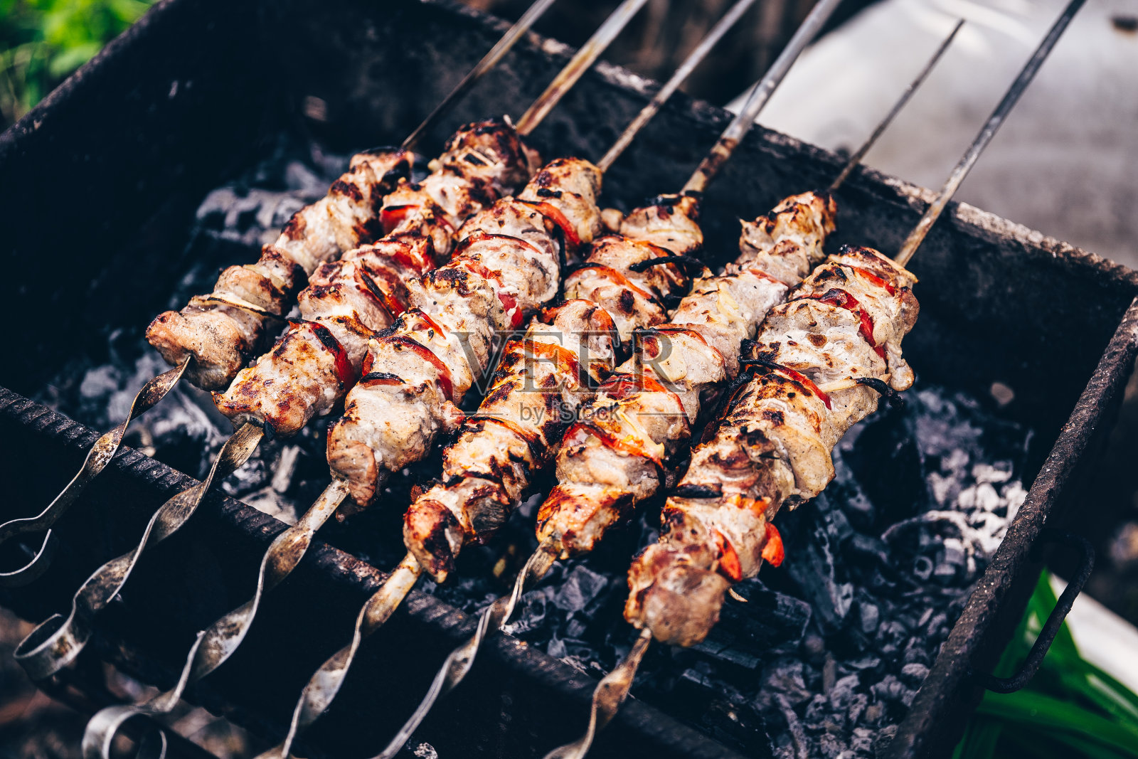 近距离的烤串。炭烤架上多汁的烧烤。户外野餐的概念照片摄影图片