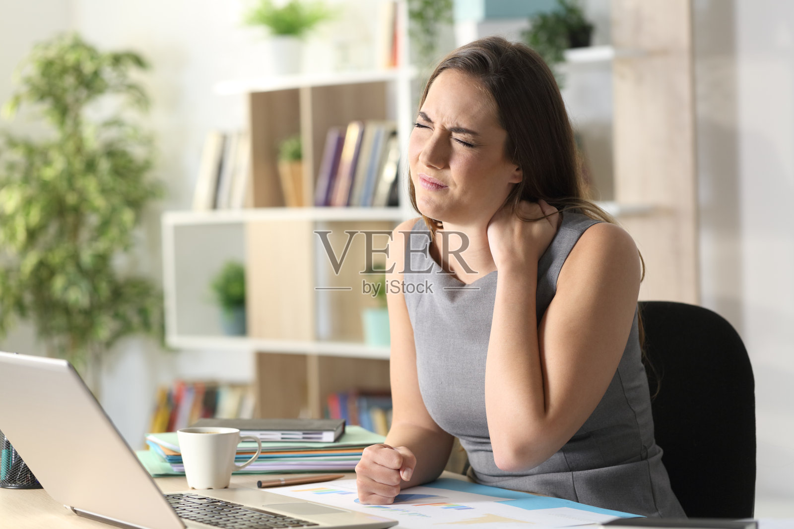 痛苦的企业家在家里忍受着脖子痛照片摄影图片