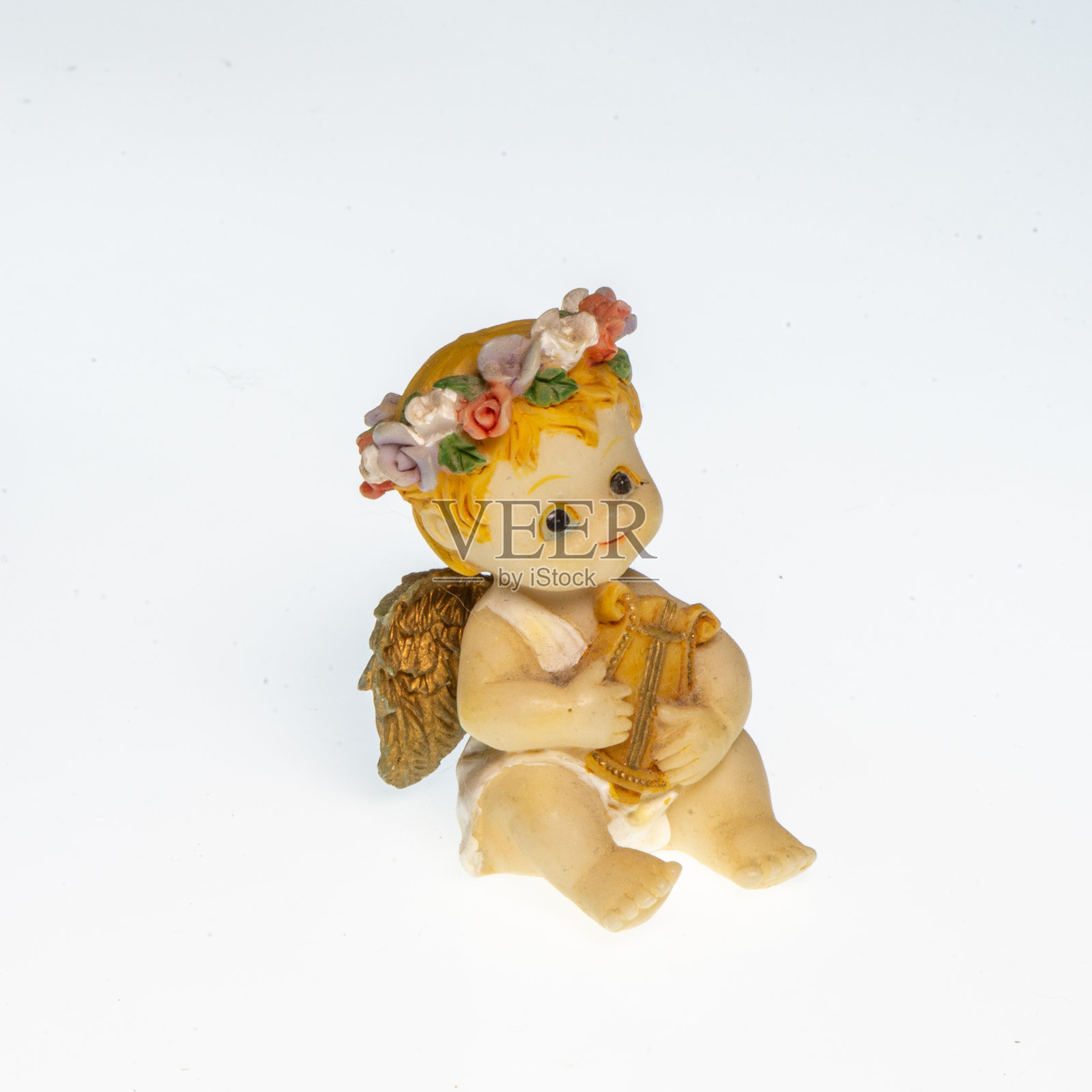 一个扮成天使弹奏竖琴的小孩的微型画照片摄影图片