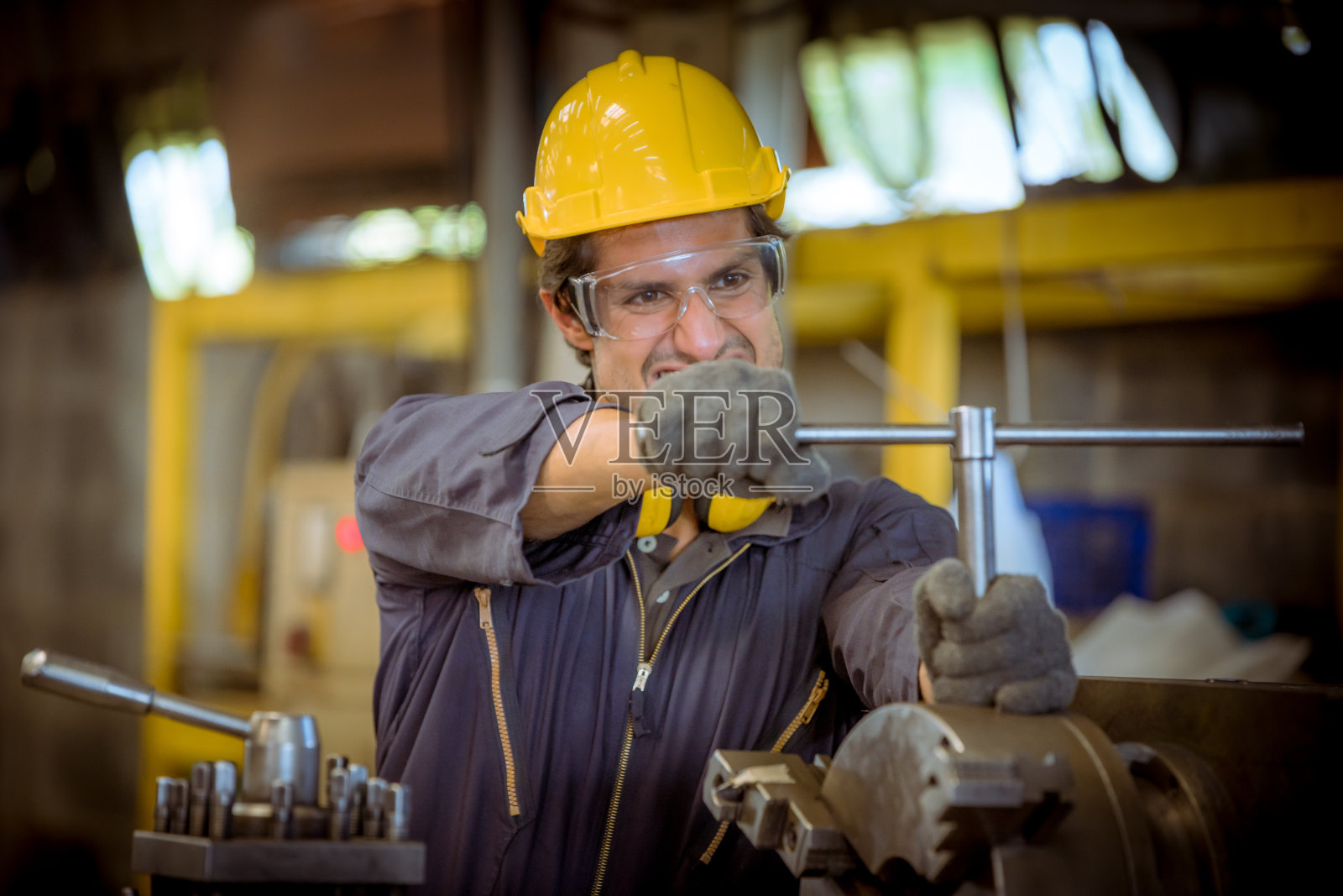 工业工程和团队穿着安全制服控制操作车床磨床在工业工厂工作。照片摄影图片