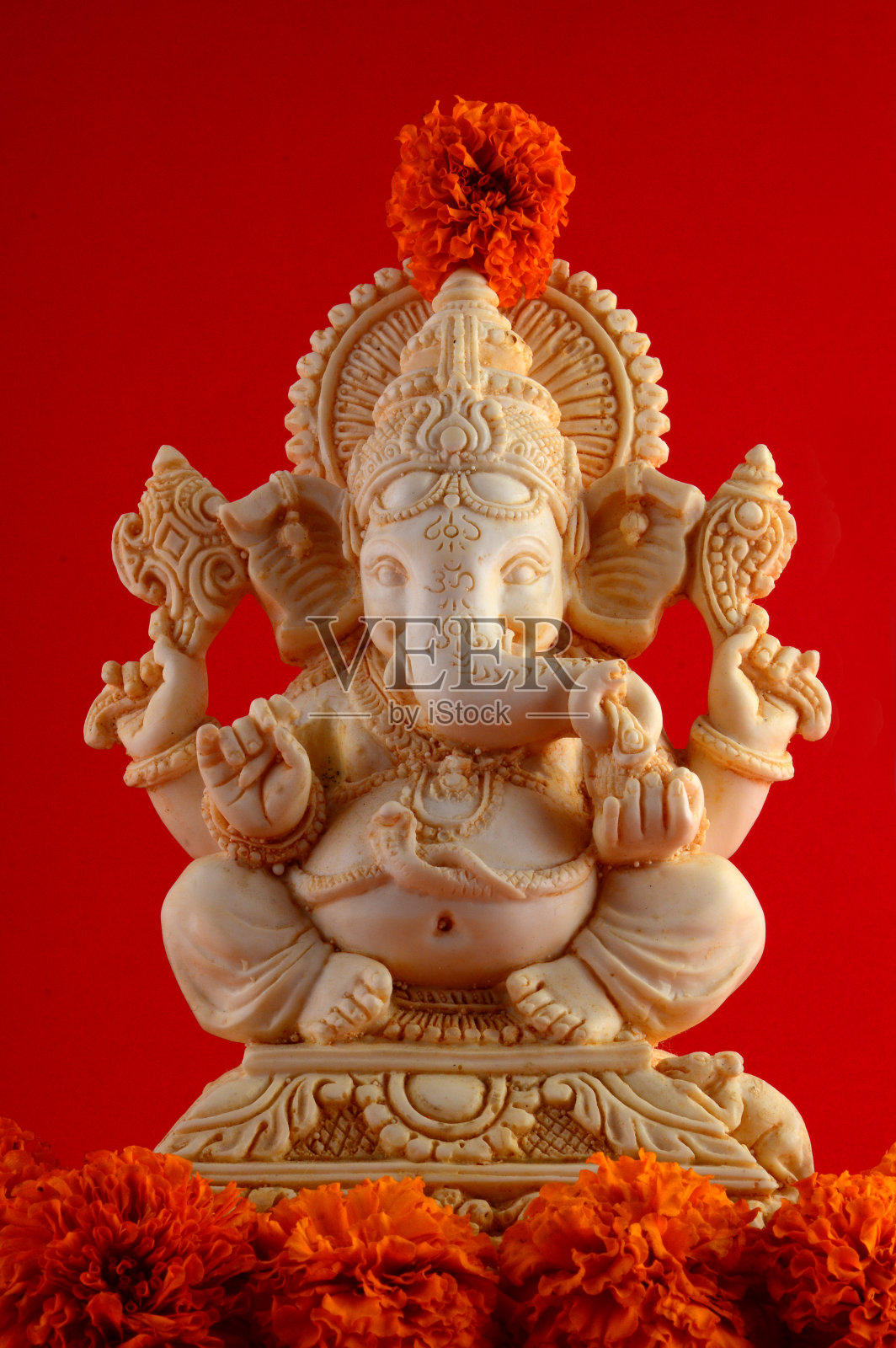 印度教神甘尼萨。甘尼萨偶像在红色的背景照片摄影图片