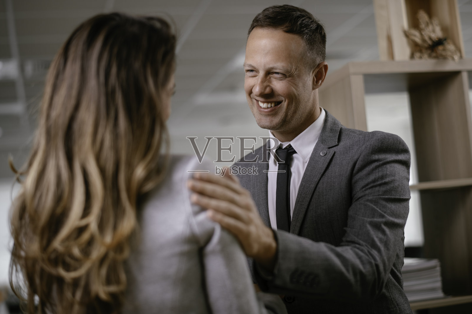 年轻男女在办公室调情。照片摄影图片