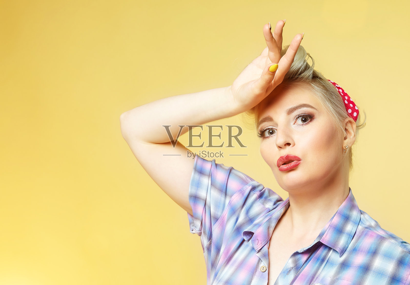 漂亮的金发女郎在黄色背景上摆姿势照片摄影图片