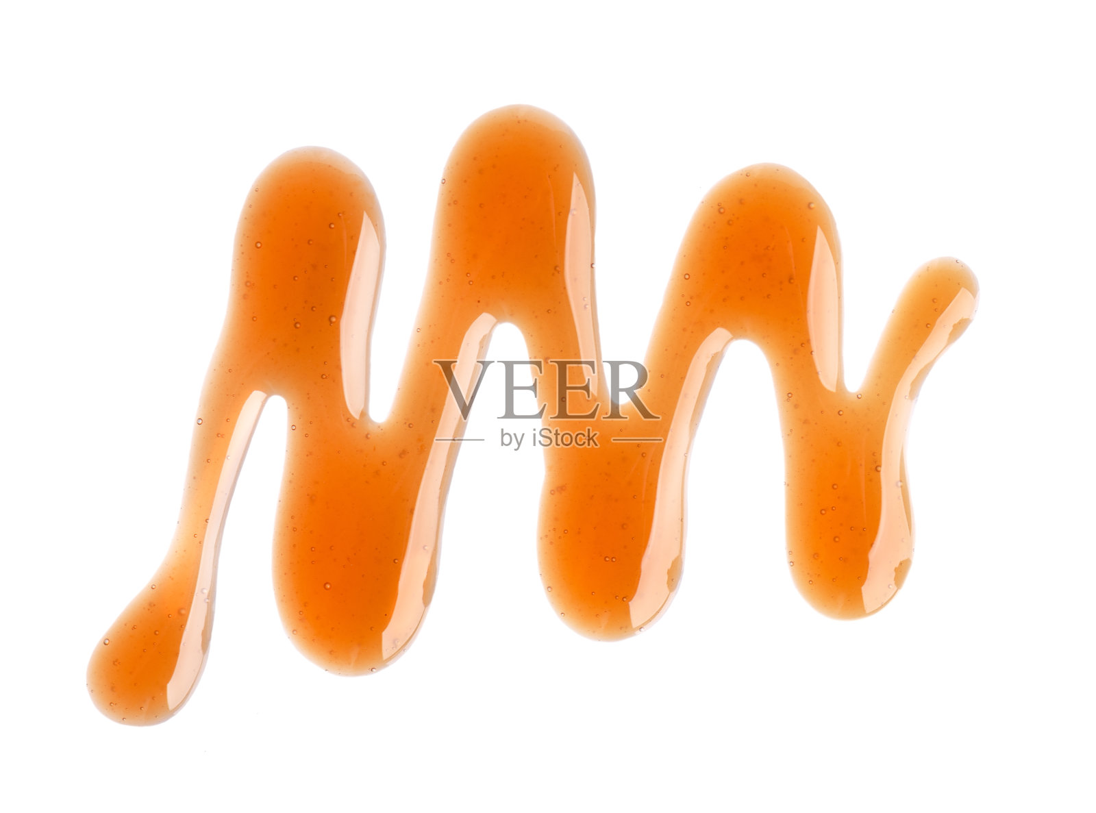 焦糖糖浆雨孤立的白色背景。撒上甜焦糖酱。前视图。照片摄影图片