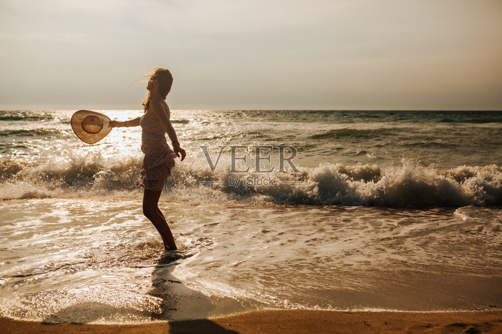 年轻漂亮的女人在沙滩上玩照片摄影图片