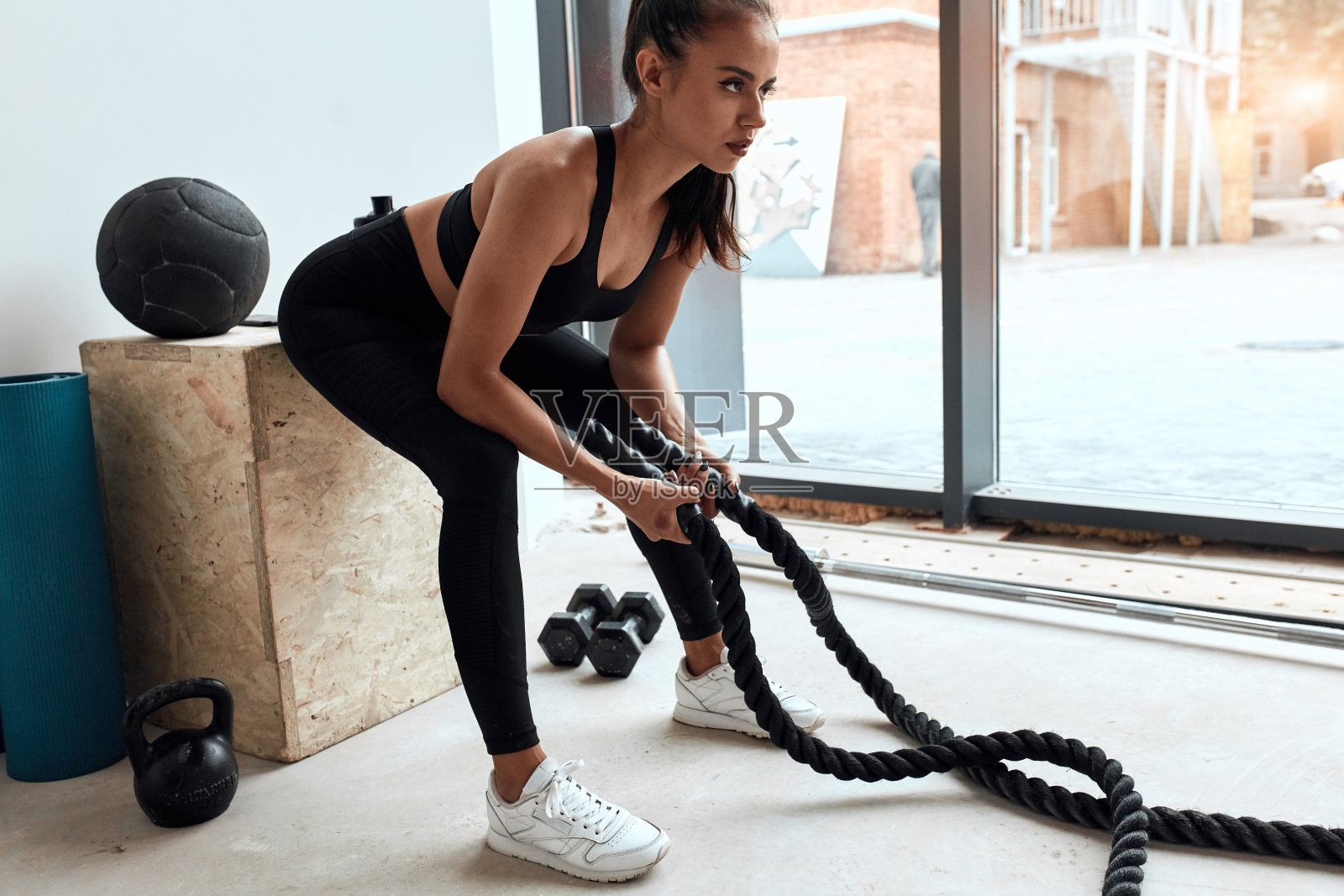 正在休息的女人在运动服拿着绳子照片摄影图片