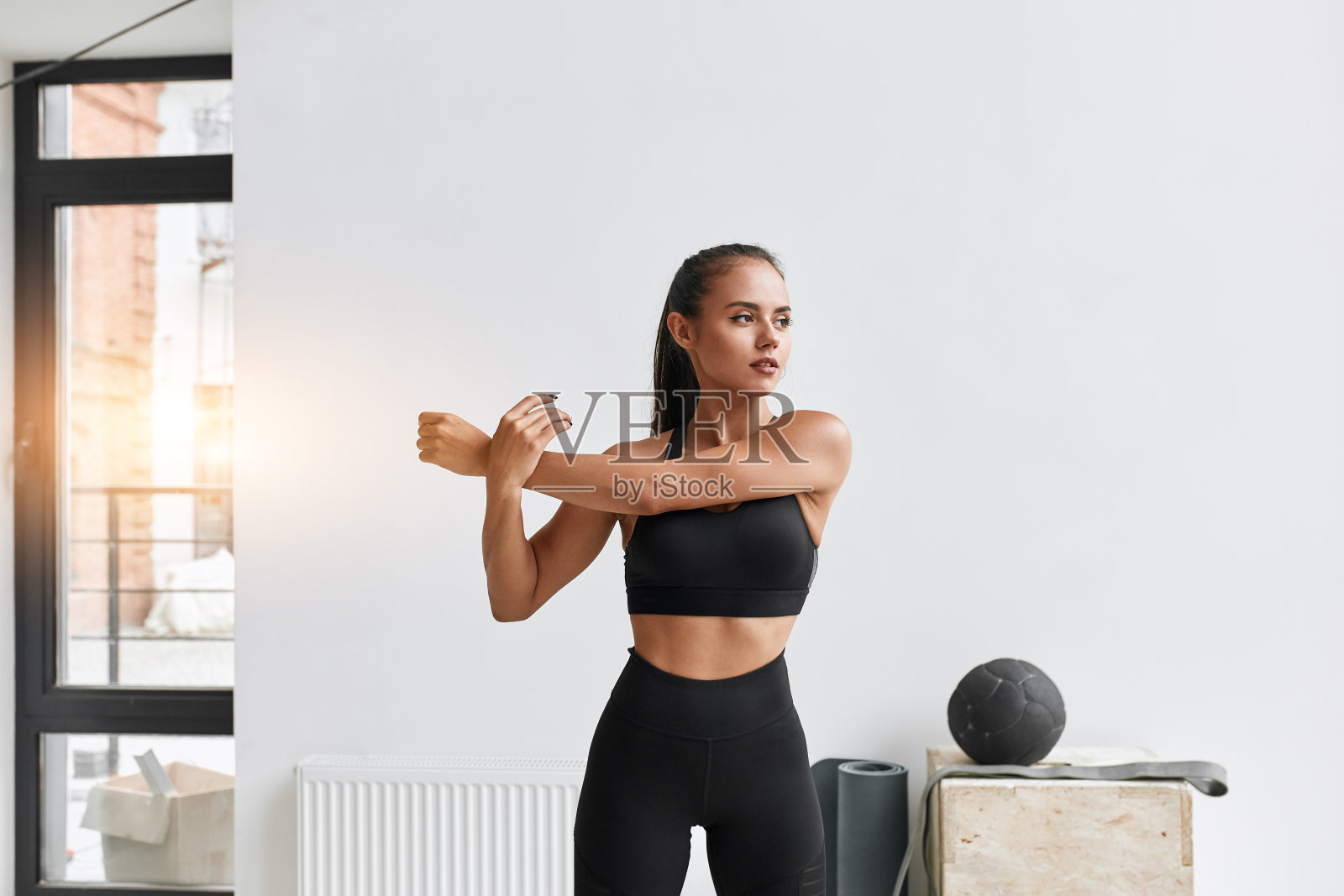 白种运动女孩在做运动前热身和伸展身体照片摄影图片