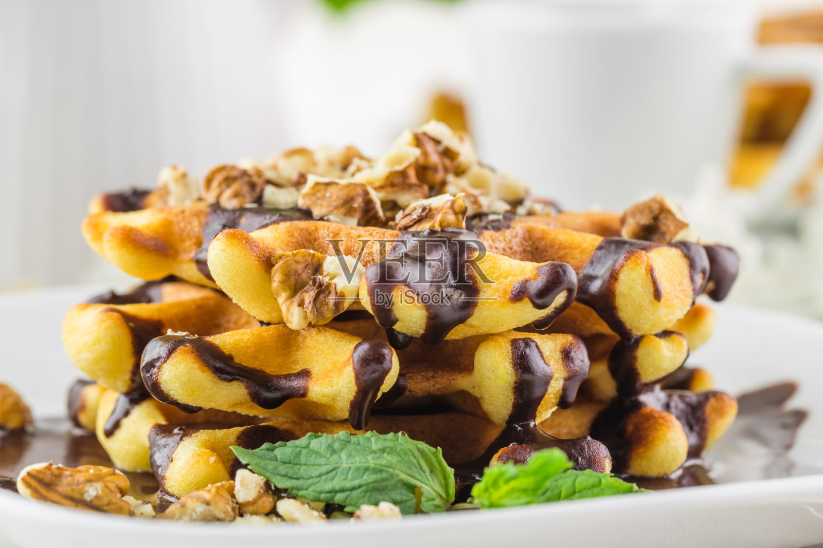 咖啡馆早餐-在房间的木桌上放着比利时华夫饼和一杯茶照片摄影图片