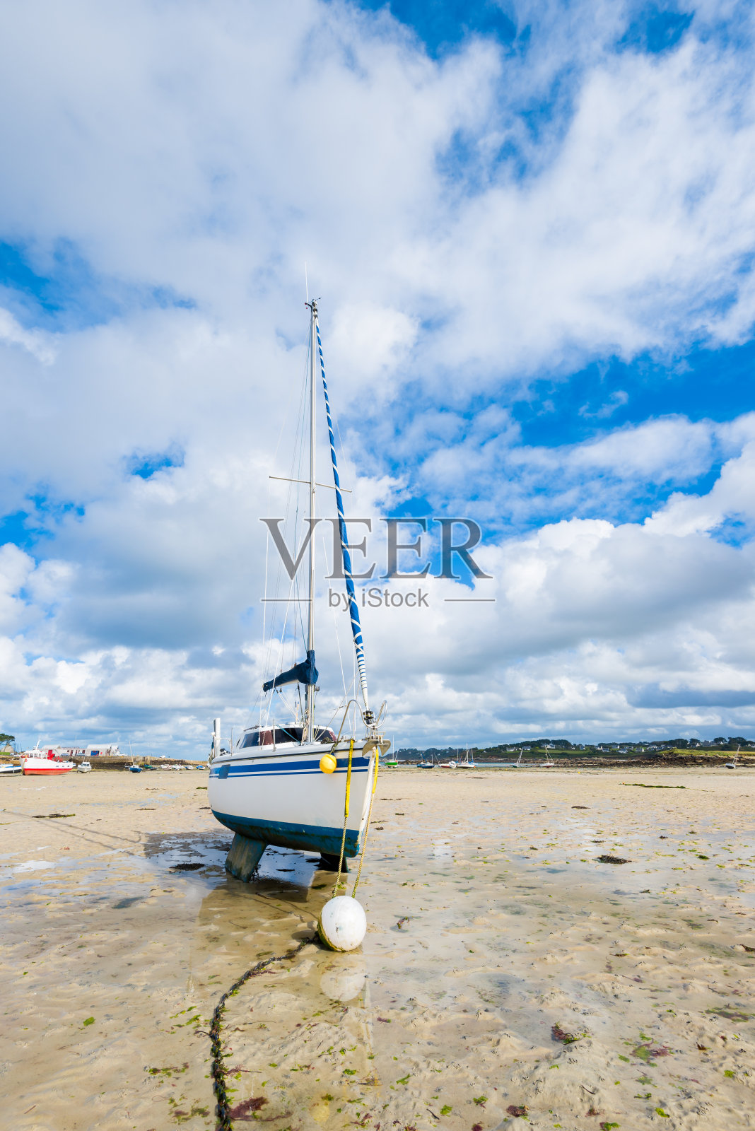 低潮期间的游艇和船只，特写。Plouguerneau、布列塔尼、法国。夏日晴空万里，蓝天白云密布照片摄影图片