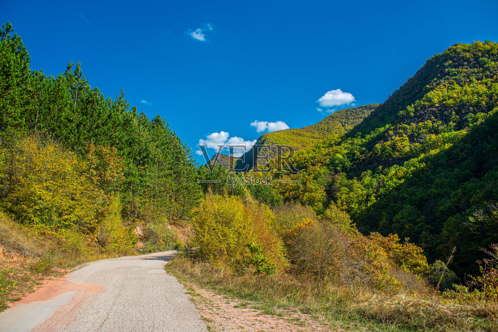 柏油路，山石景观，阳光灿烂的天空照片摄影图片