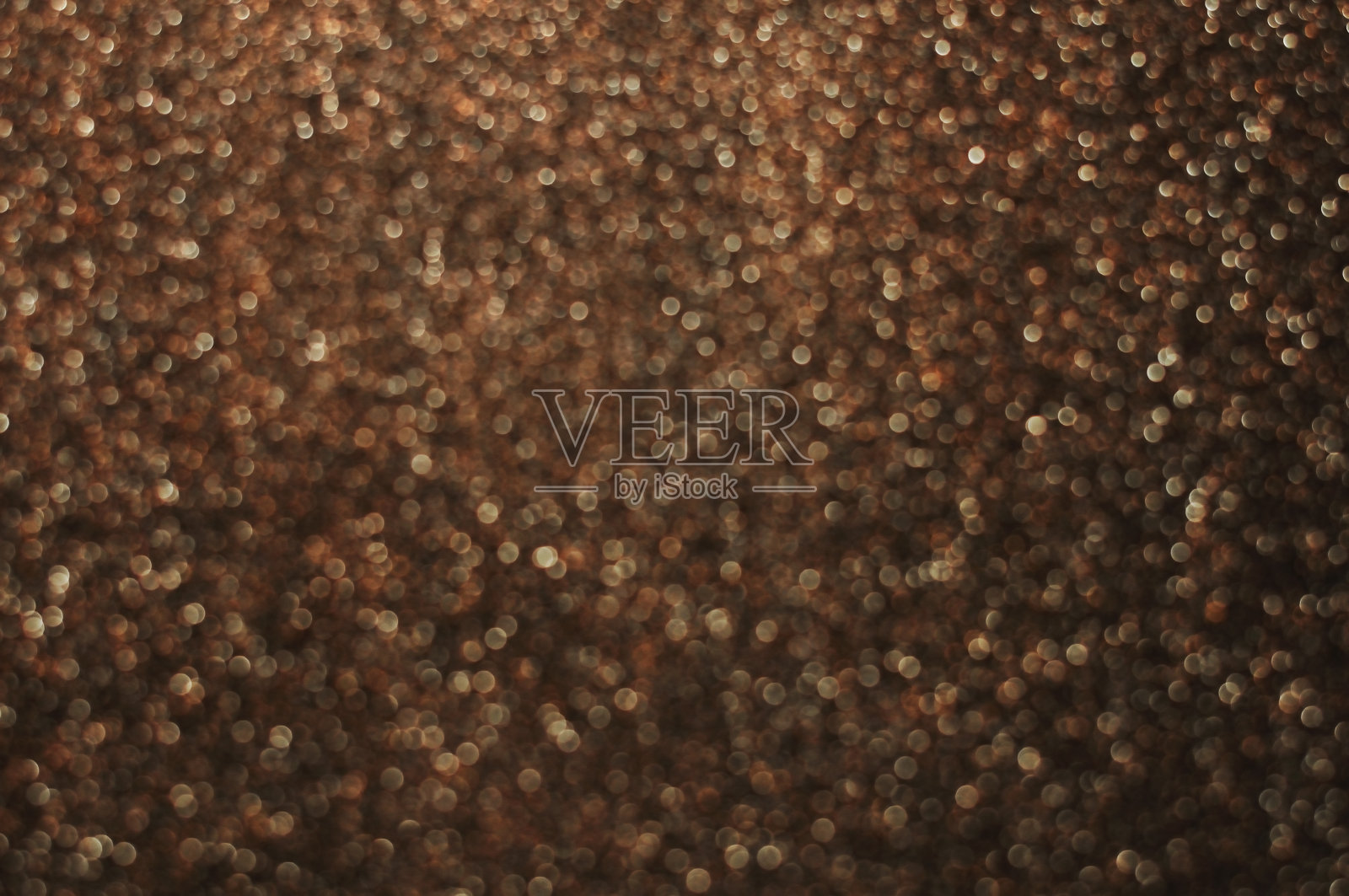 暗金色和棕色抽象散景灯。散焦背景照片摄影图片