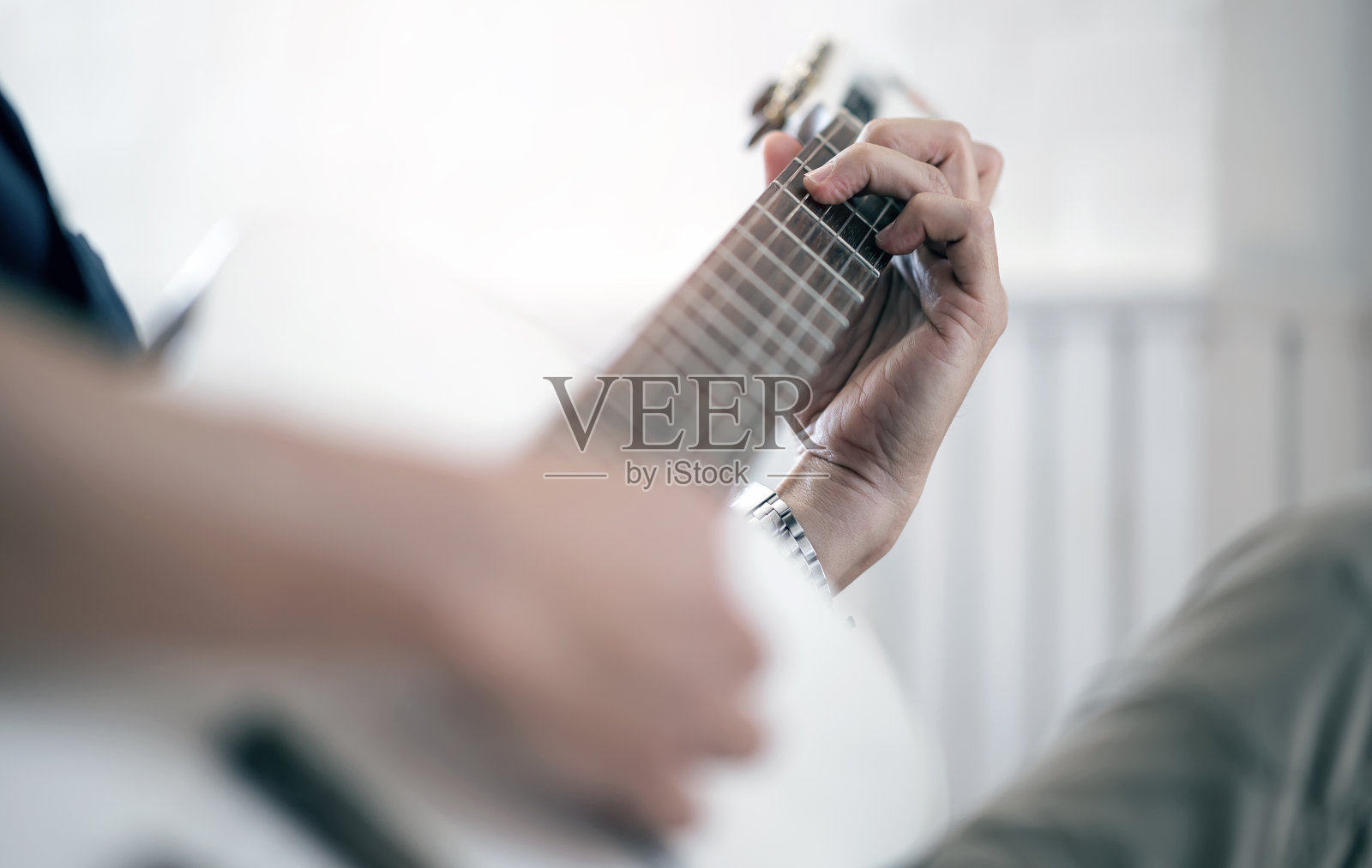 男子弹吉他的特写镜头。照片摄影图片