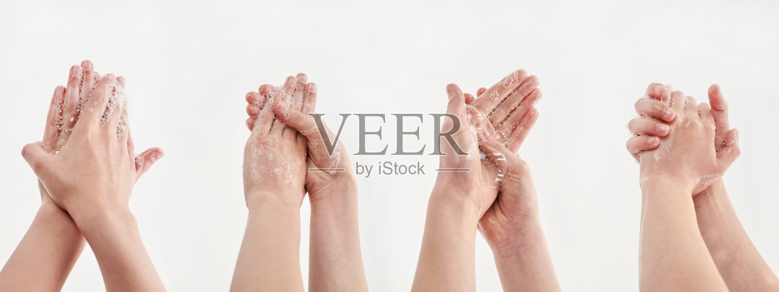 白色背景上用肥皂洗手的过程。一个小女孩用肥皂洗手。冠状病毒或Covid-19概念。照片摄影图片