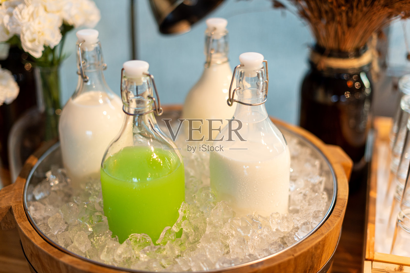 bottle牛奶和果汁在一个冰篮子里照片摄影图片