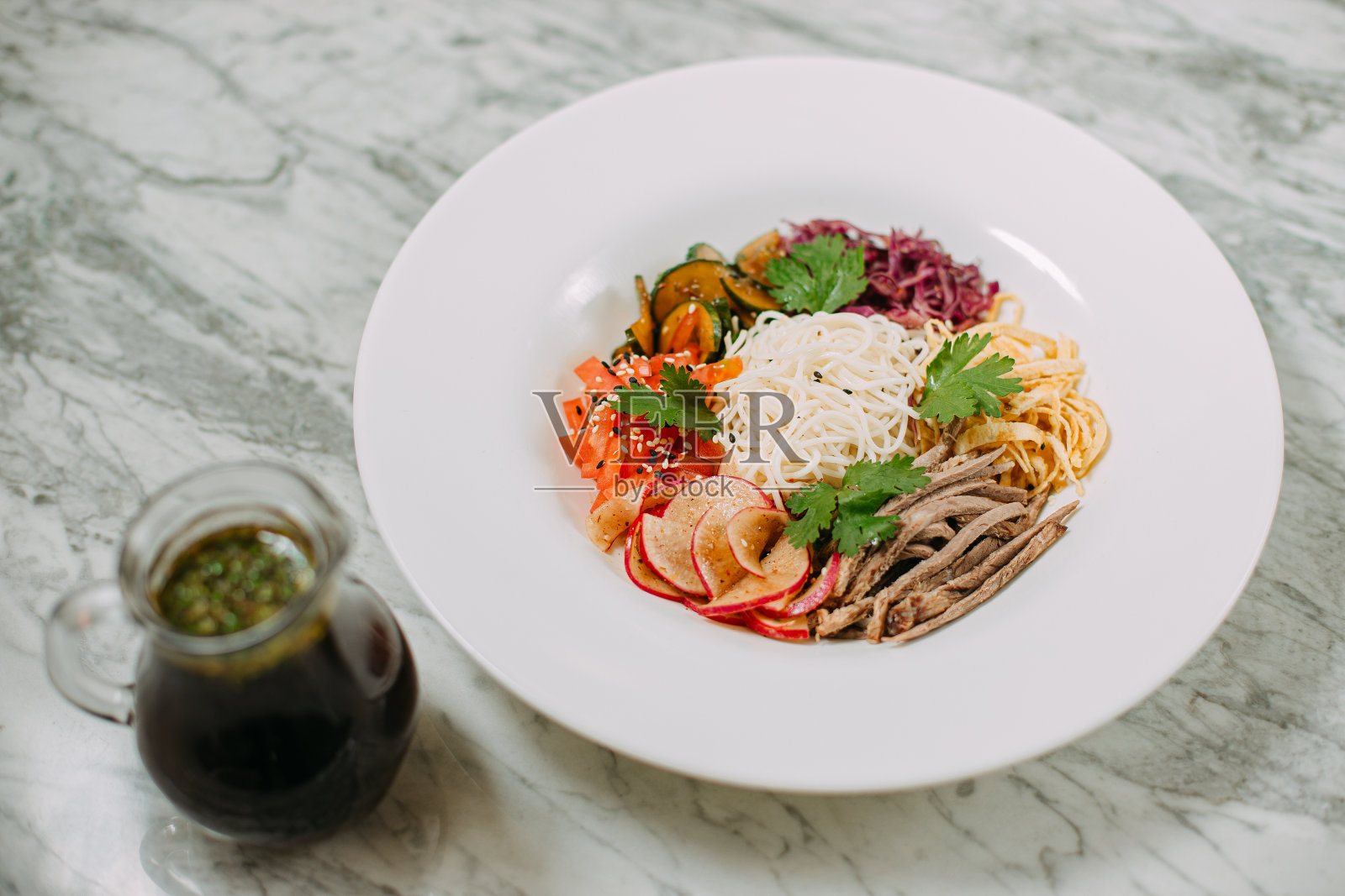 在大理石桌子上的白色盘子里，放着制作韩国土豆泥的原料照片摄影图片