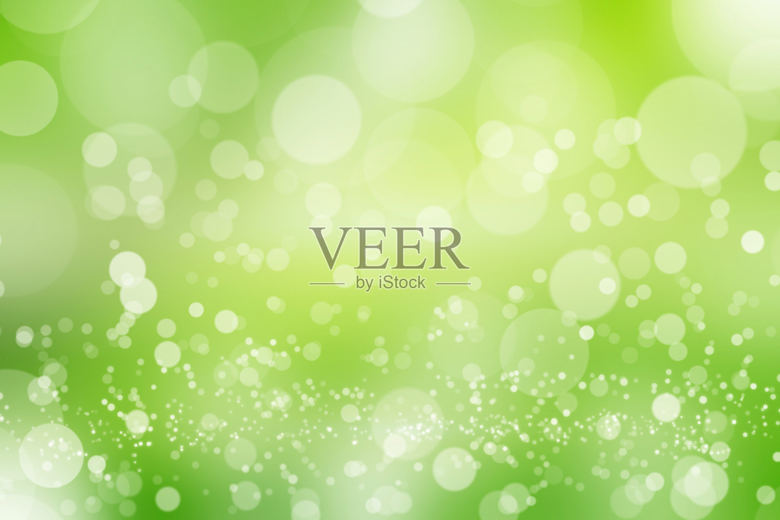 绿色模糊背景上的抽象散景。照片摄影图片