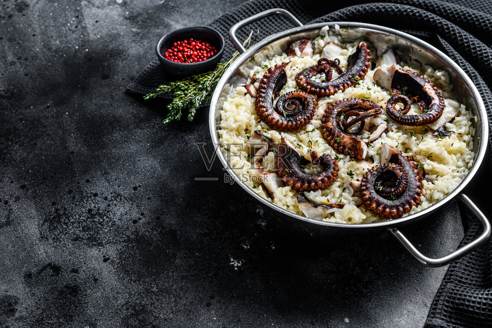 自制章鱼意大利调味饭。黑色背景。前视图。本空间照片摄影图片