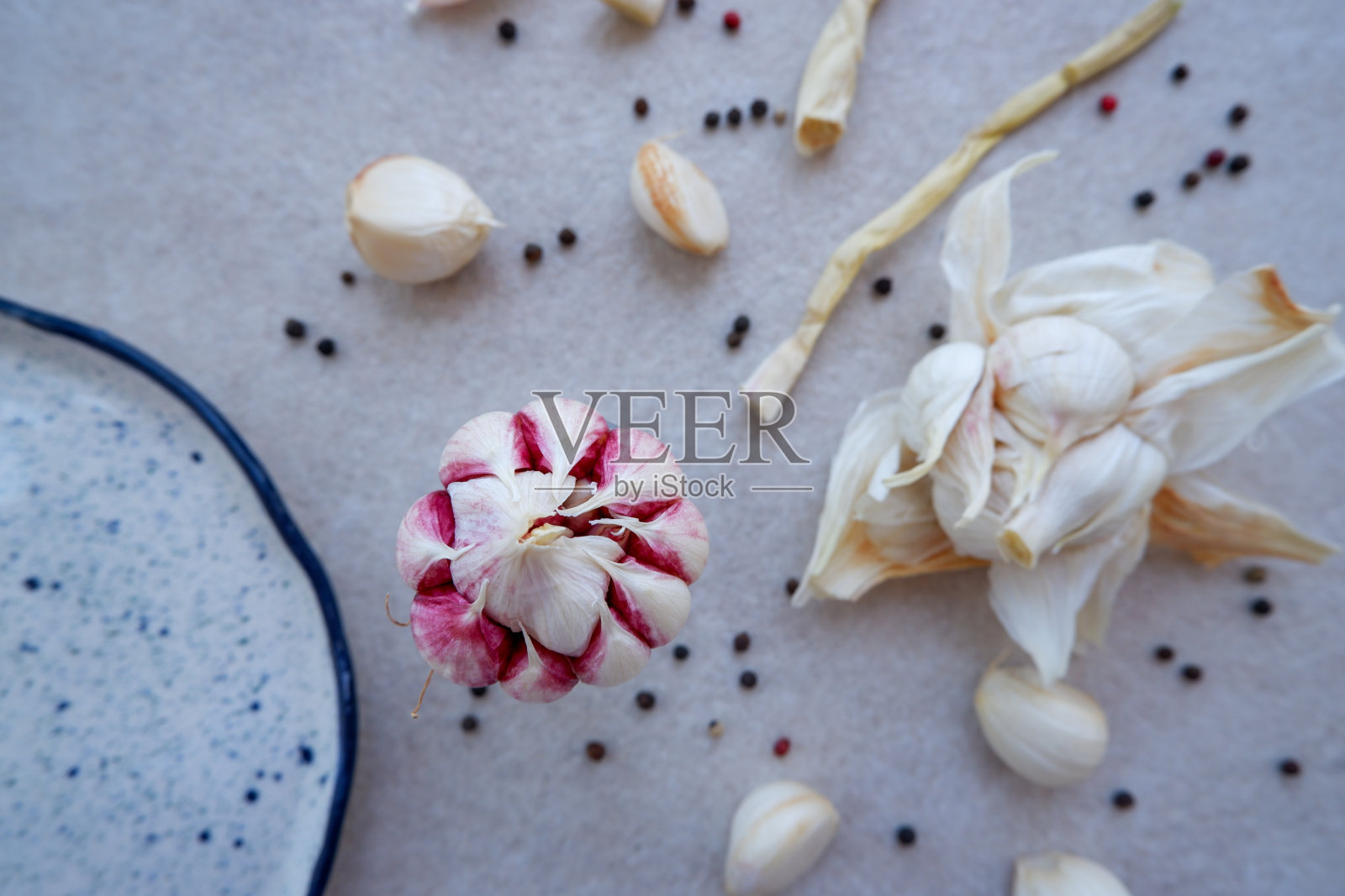 平铺一层大蒜，蒜瓣和黑胡椒。照片摄影图片