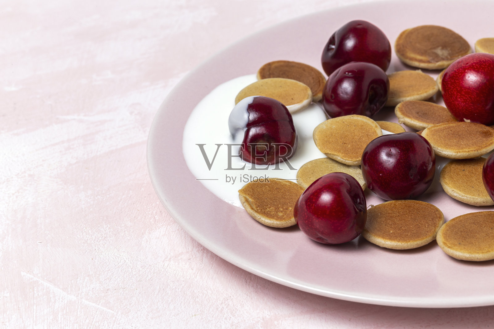 自制麦片迷你煎饼，酸奶，蜂蜜和草莓在彩色的背景。照片摄影图片