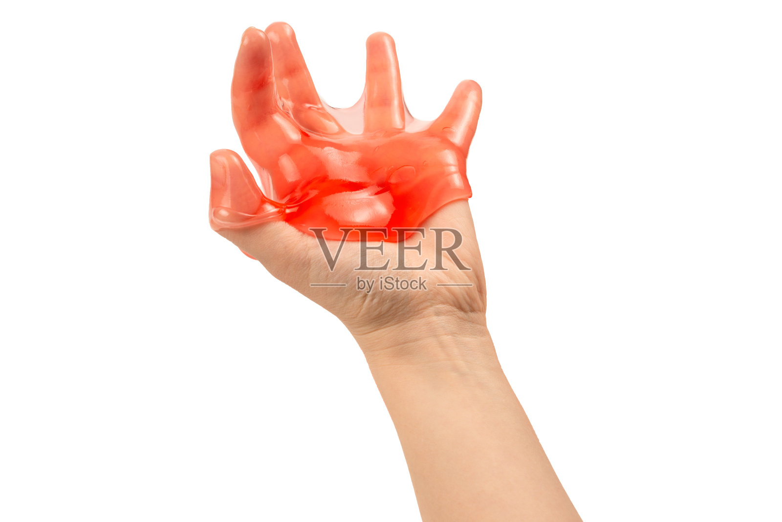 红色黏液玩具在女人手上孤立在白色。照片摄影图片