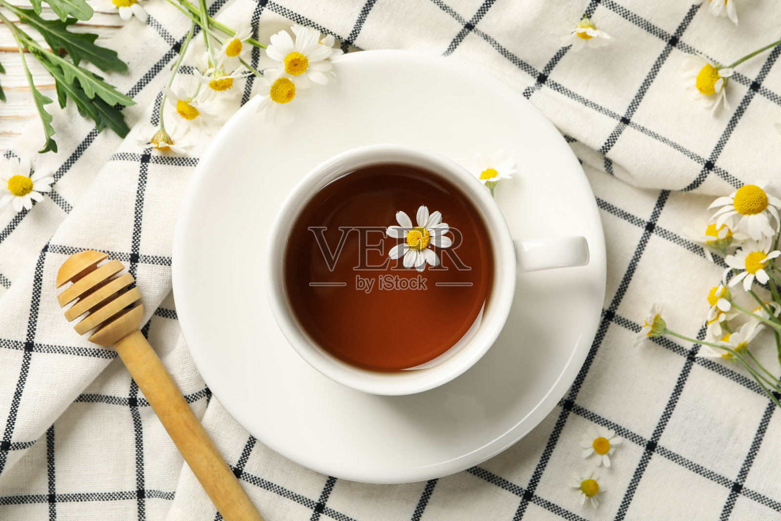 以一杯洋甘菊茶为背景，以白色木质为背景照片摄影图片