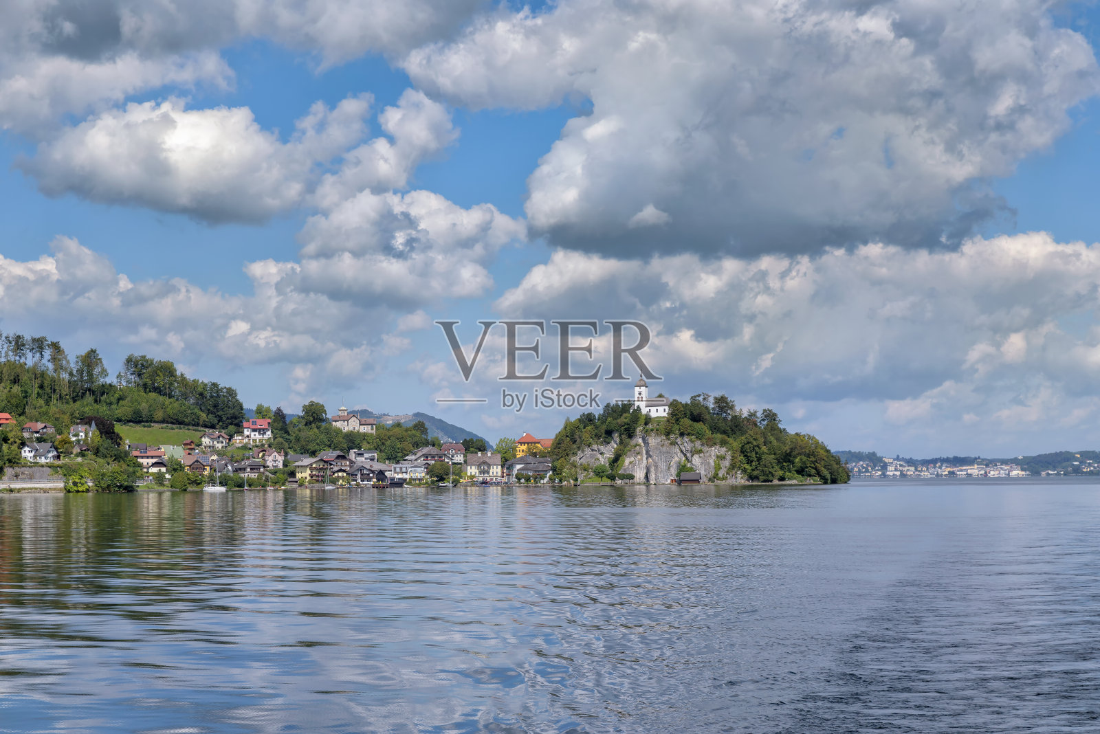 俯瞰特朗西湖到格蒙登附近的特朗基兴村庄，在天空中风景如画的云彩下有约翰尼斯堡教堂。萨尔兹卡默古特，上奥地利，欧洲照片摄影图片