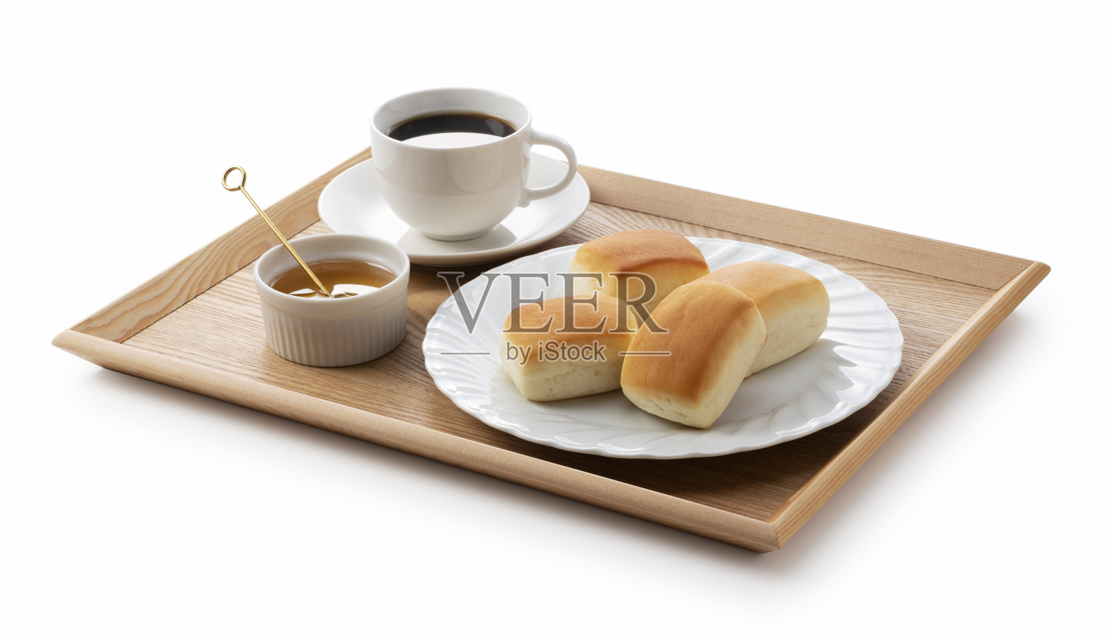晚餐面包卷，咖啡和蜂蜜放在木托盘上照片摄影图片
