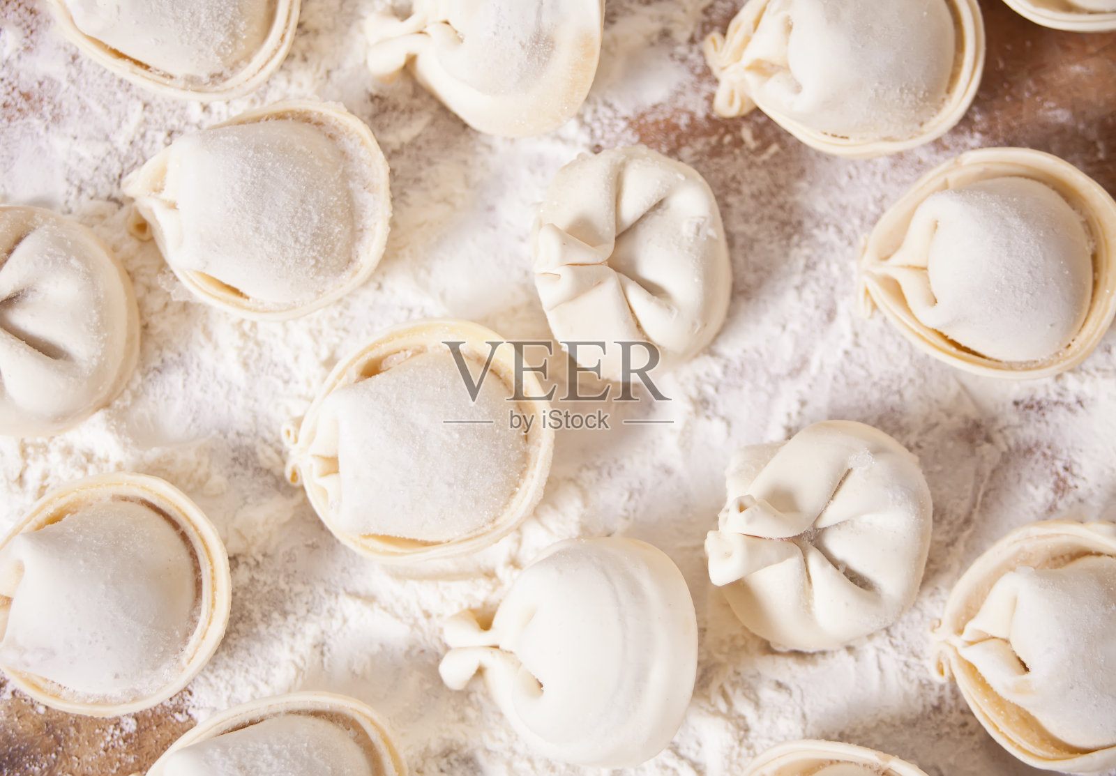 自制生俄罗斯水饺肉饺子意大利饺子放在砧板上。照片摄影图片