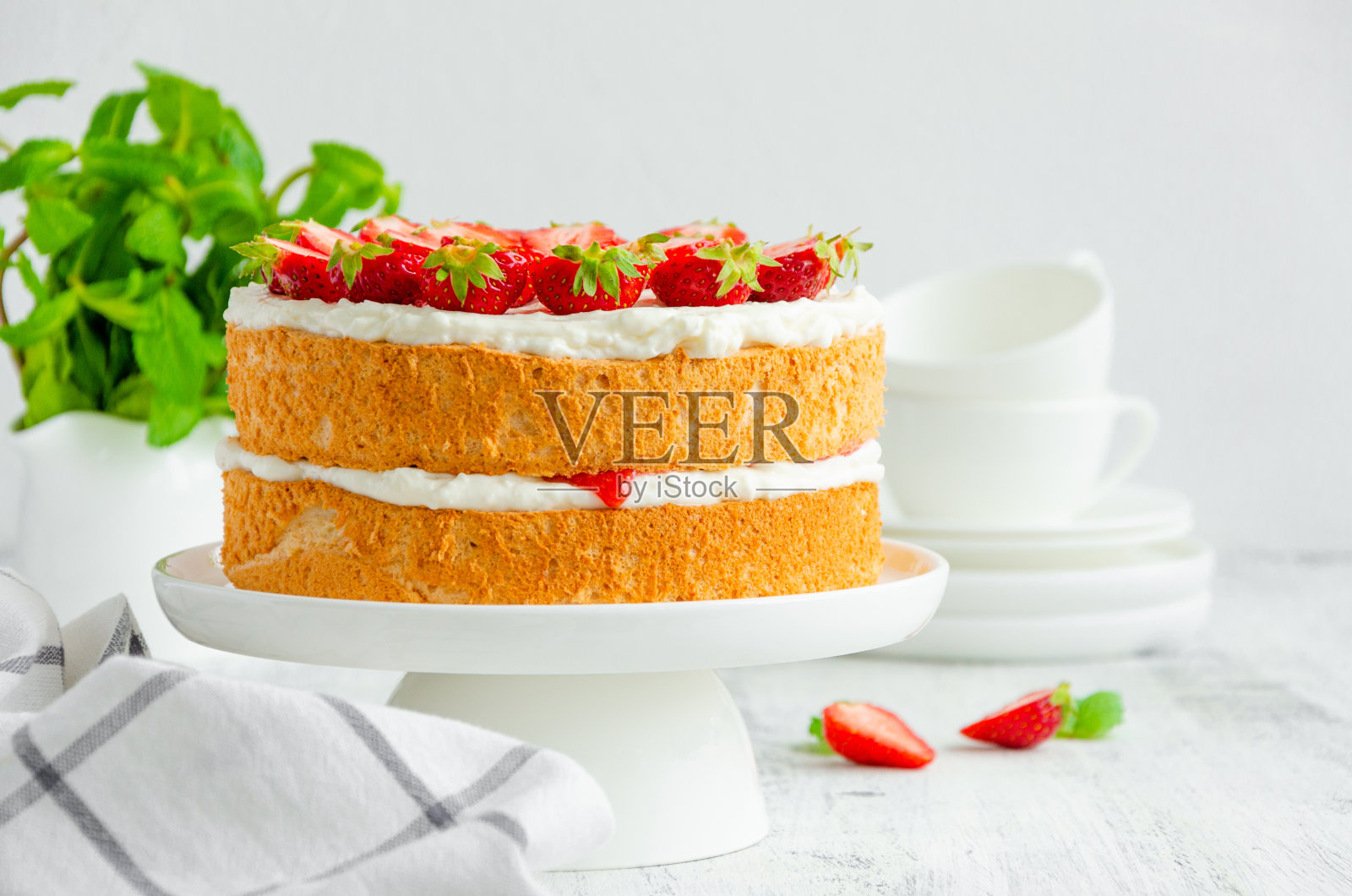 维多利亚海绵蛋糕，草莓酱，鲜奶油和新鲜草莓放在白色的盘子上，木制的背景。水平方向，复制空间。照片摄影图片