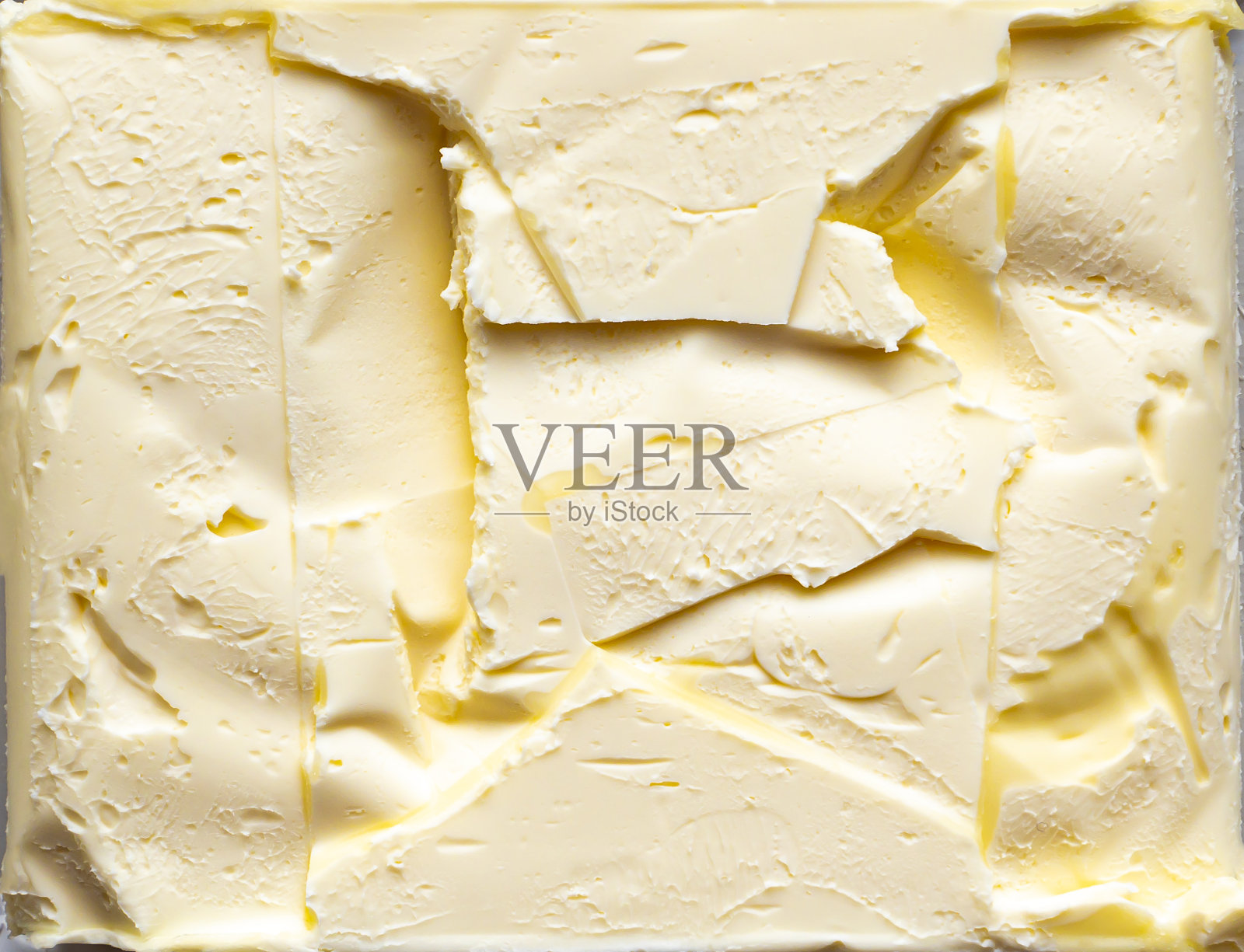 黄油表面的纹理与包装的印象。照片摄影图片