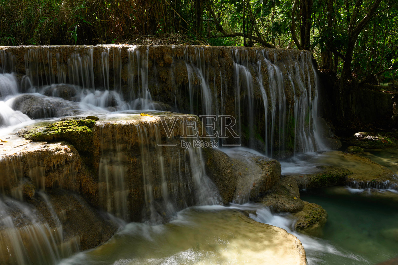 从老挝琅勃拉邦匡斯瀑布侧面看到的瀑布。照片摄影图片